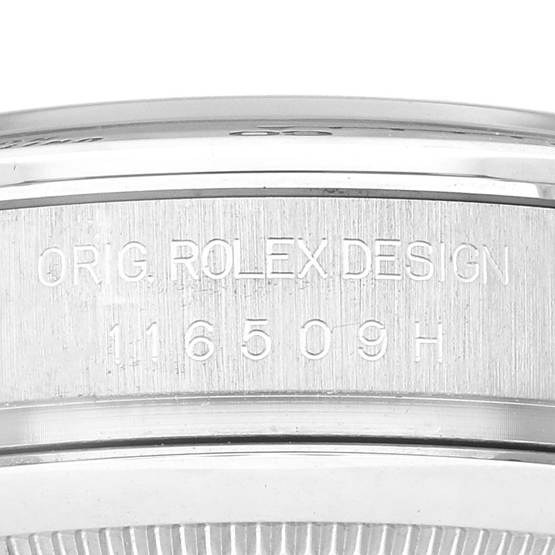 This image shows a close-up of the side engraving on a Rolex Daytona 116509 Men's White Gold Blue Dial 116509 Men's White Gold Blue Dial watch, displaying "ORIG. ROLEX DESIGN 116509H."