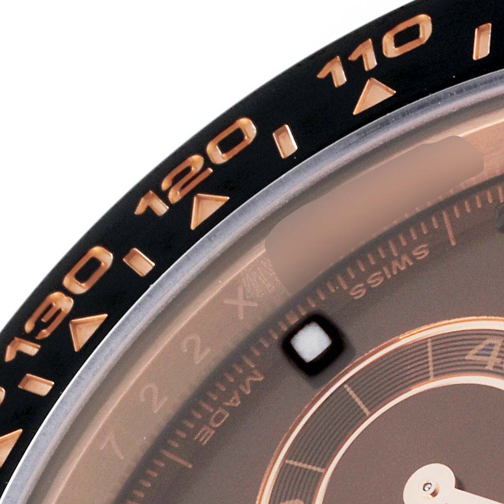 The image shows a close-up of the bezel and part of the dial on the Rolex Daytona 116515 Men's Rose Gold Brown Dial watch.
