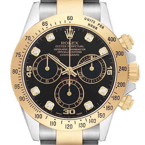 The Rolex Daytona 116523 Men's Steel and Gold (two tone) Black Dial watch is shown from the front, displaying its gold bezel, black dial, diamond hour markers, and chronograph subdials.