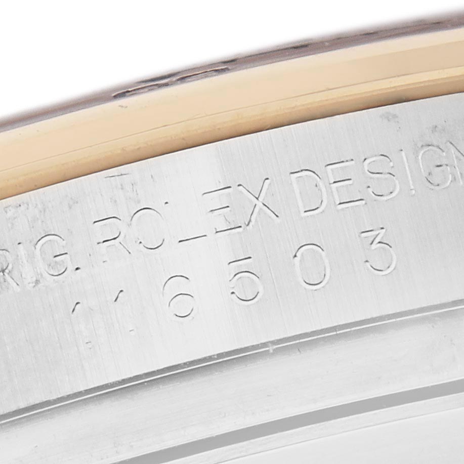 The image shows a close-up angle of the side engraving on a Rolex Daytona 116503 Men's Steel and Gold (two tone) Mother of Pearl Dial 116503 Men's Steel and Gold (two tone) Mother of Pearl Dial watch bezel.