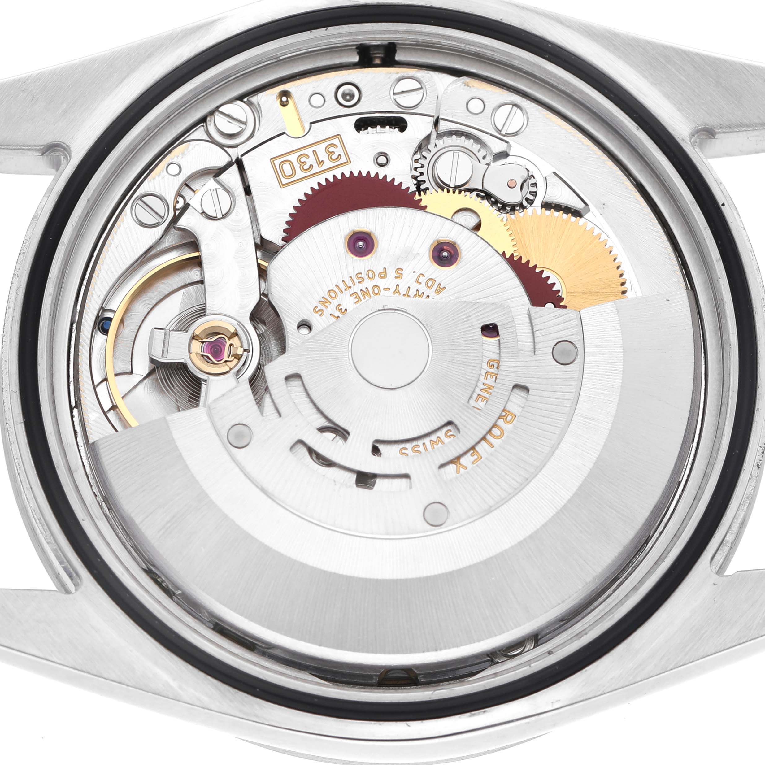The image shows the back of a Rolex Explorer 114270 Men's Stainless Steel Black Dial watch, highlighting its intricate mechanical movement.