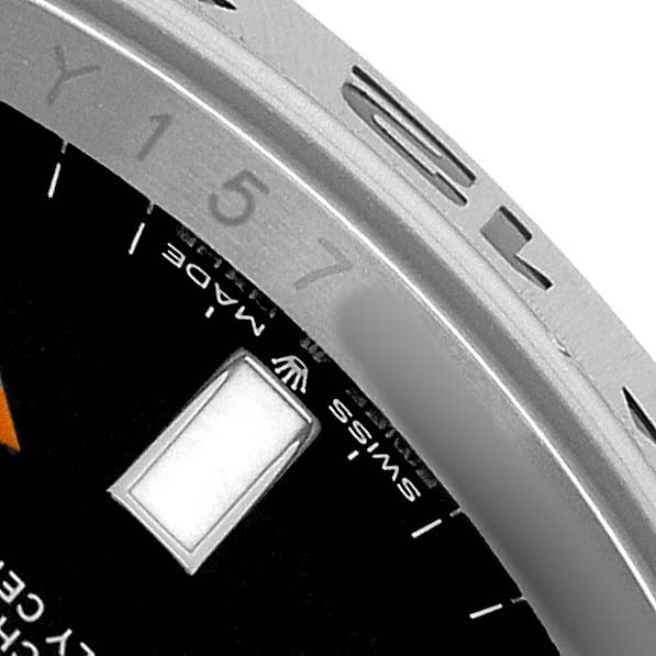The image shows a close-up of the Rolex Explorer 226570 Men's Stainless Steel Black Dial watch's bezel, partial dial, and a rectangular marker.