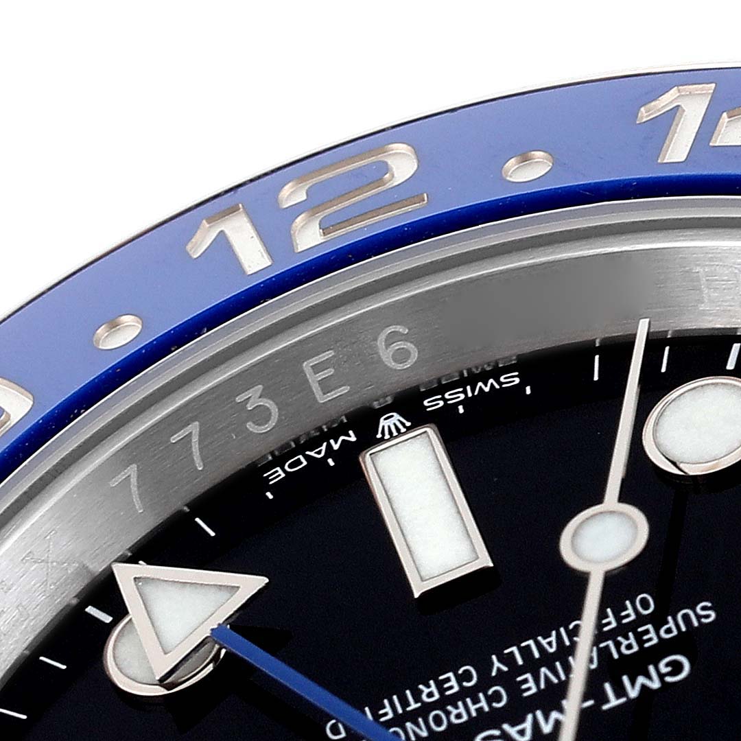 This image shows a close-up view of the bezel and part of the dial of a Rolex GMT-Master 126710 Men's Stainless Steel Black Dial 126710 Men's Stainless Steel Black Dial watch.
