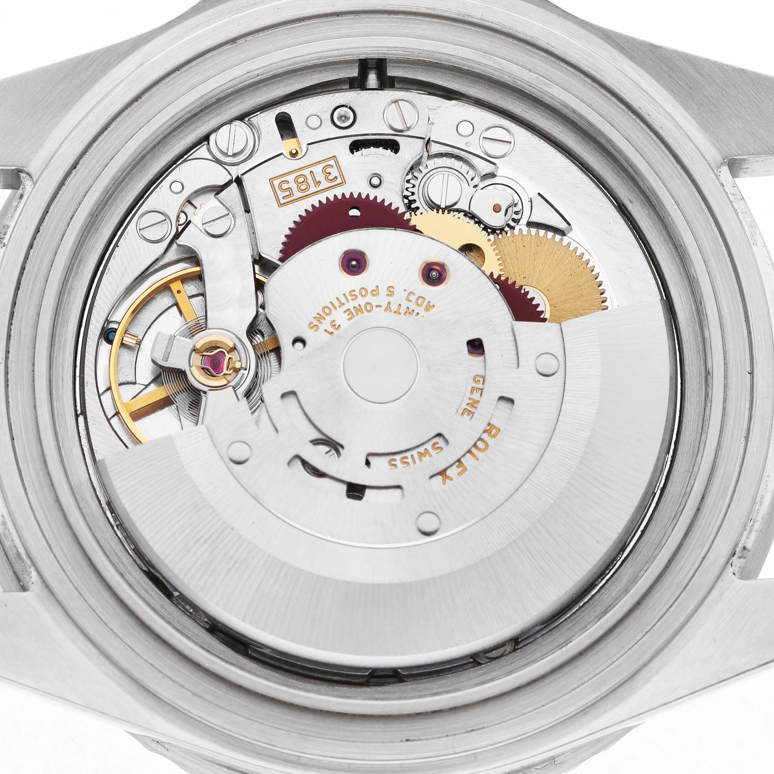 The image shows the inner mechanism of a Rolex GMT-Master 16710 Men's Stainless Steel Black Dial watch, highlighting gears and movement parts.