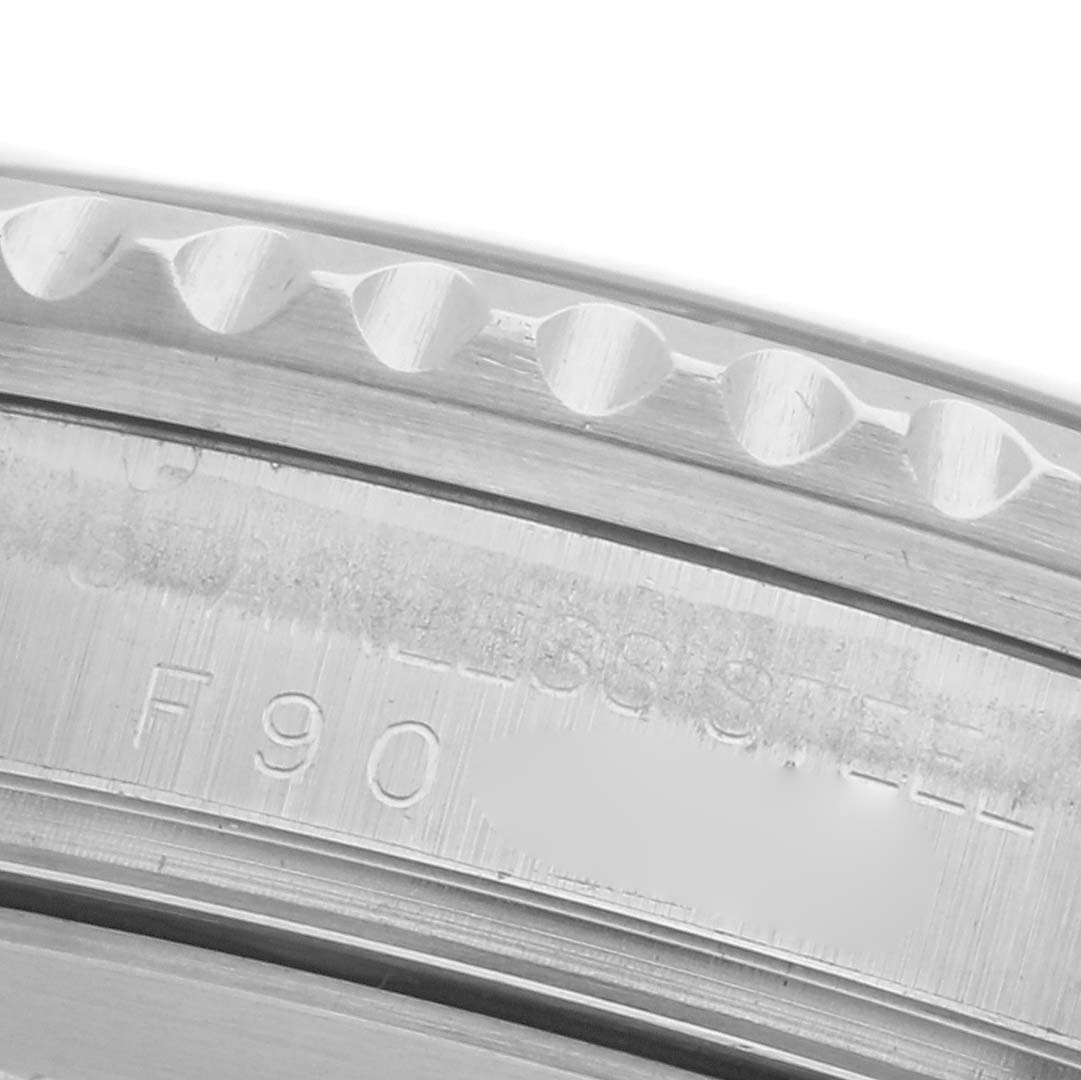 The image shows a close-up of the side of a Rolex GMT-Master 16710 Men's Stainless Steel Black Dial 16710 Men's Stainless Steel Black Dial, focusing on the bezel edge and inscriptions.