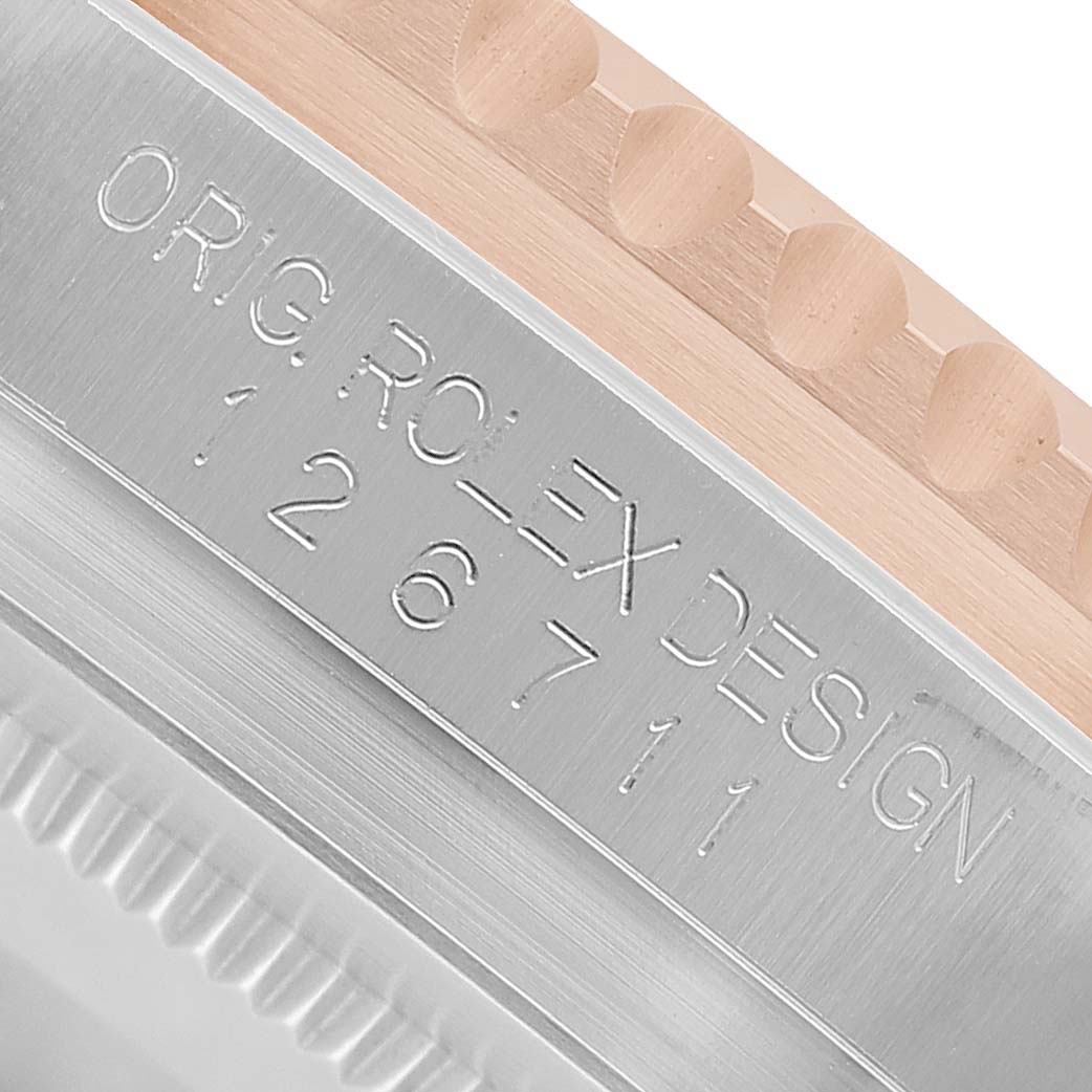 This image shows a close-up angle of the case side and bezel of a Rolex GMT-Master 126711CHNR Men's Steel and Gold (two tone) Black Dial, highlighting the model number engraving.