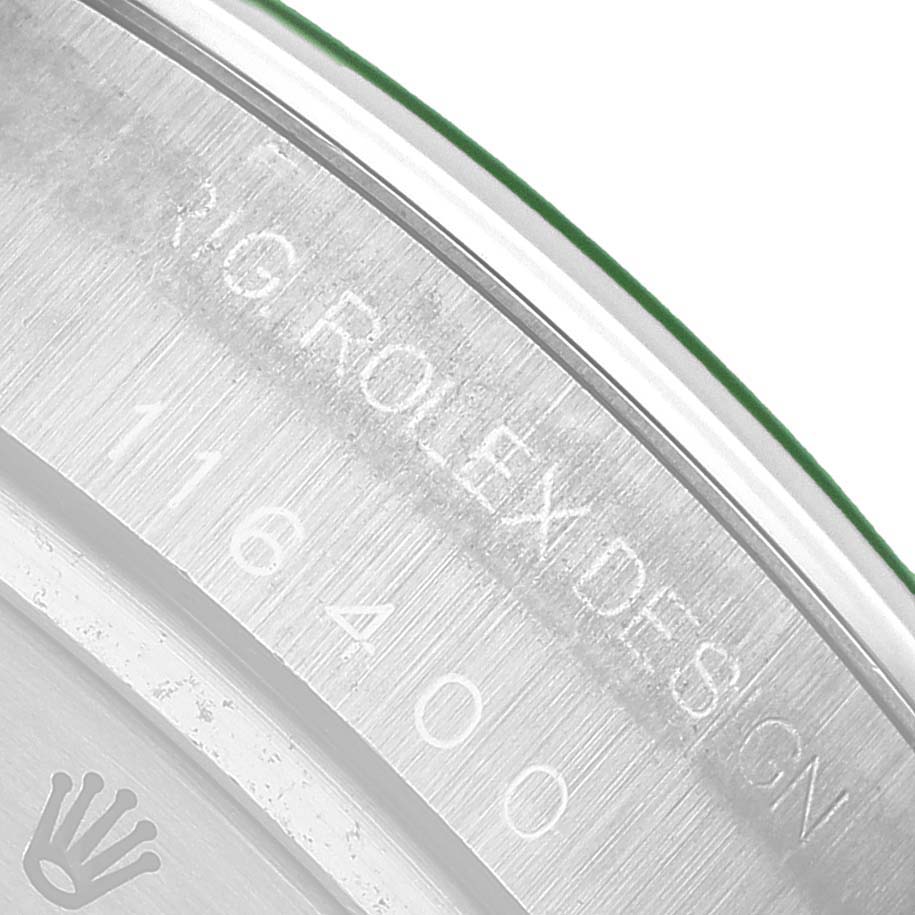 The image shows a close-up of the inner bezel and case back edge of a Rolex Milgauss 116400 Men's Stainless Steel Blue Dial, highlighting the engraving.
