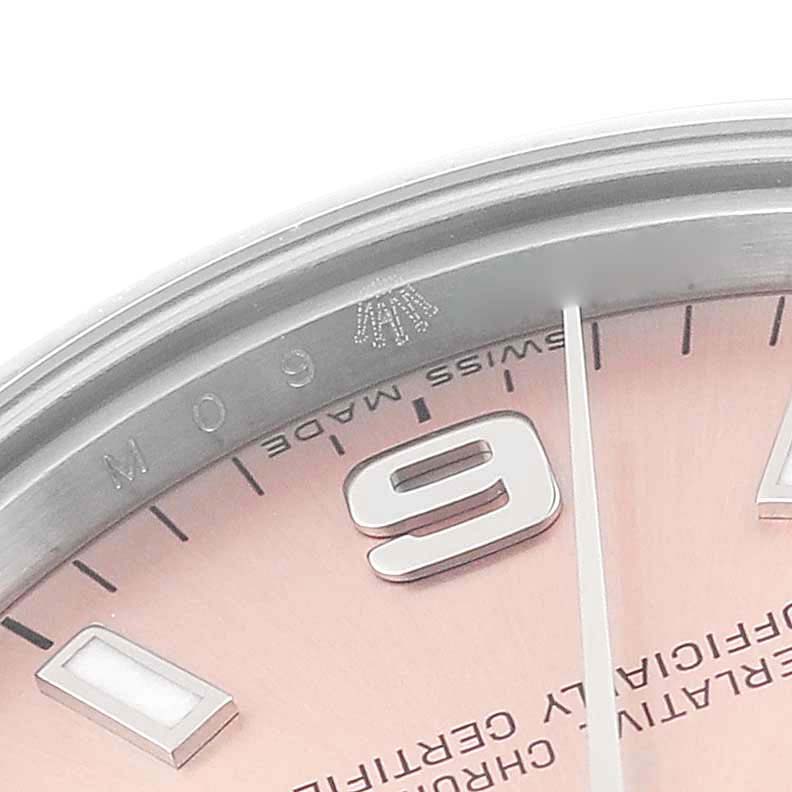 This close-up image shows the dial and bezel of a Rolex Mid-Size 177200 Women's Stainless Steel Pink Dial 177200 Women's Stainless Steel Pink Dial watch featuring the number 9, markers, and part of the text.