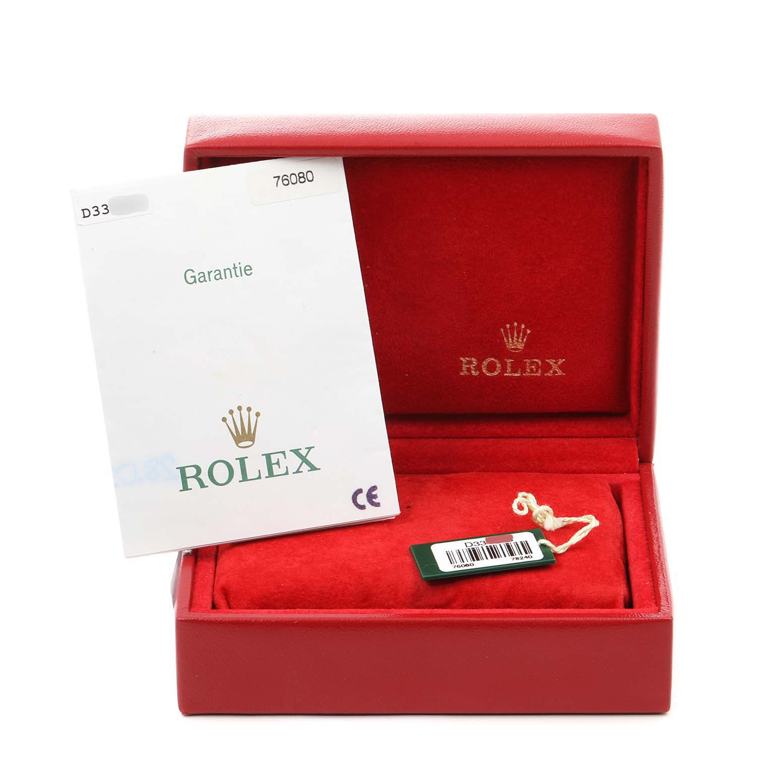 The image shows a red Rolex box for the Oyster Perpetual model, including a warranty card and a tag inside.