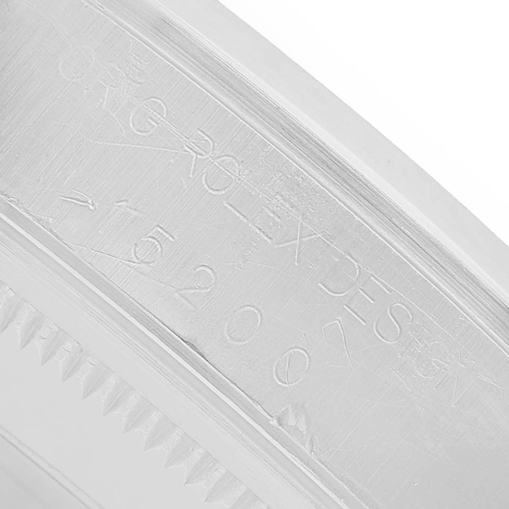 The image shows the engraved inner bezel of a Rolex Date 15200 Men's Stainless Steel Silver Dial model watch at a close angle.