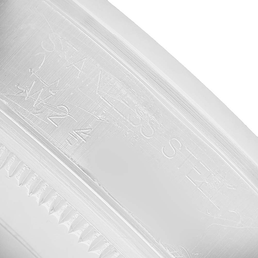 The image shows a close-up of the Rolex Date 15200 Men's Stainless Steel Silver Dial model's stainless steel case or bezel with engraved text.