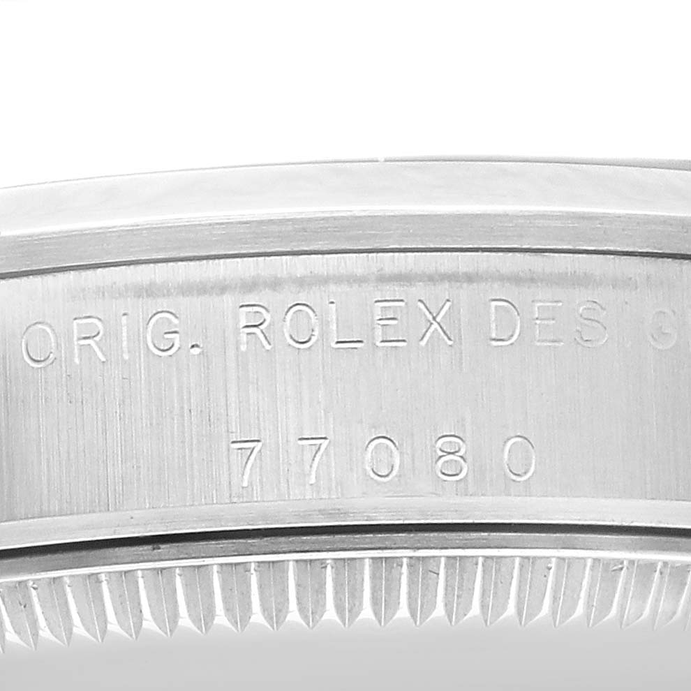 The image shows a close-up of the case side of the Rolex Mid-Size 77080 Women's Stainless Steel Black Dial 77080 Women's Stainless Steel Black Dial model, displaying the engraved reference number 77080.