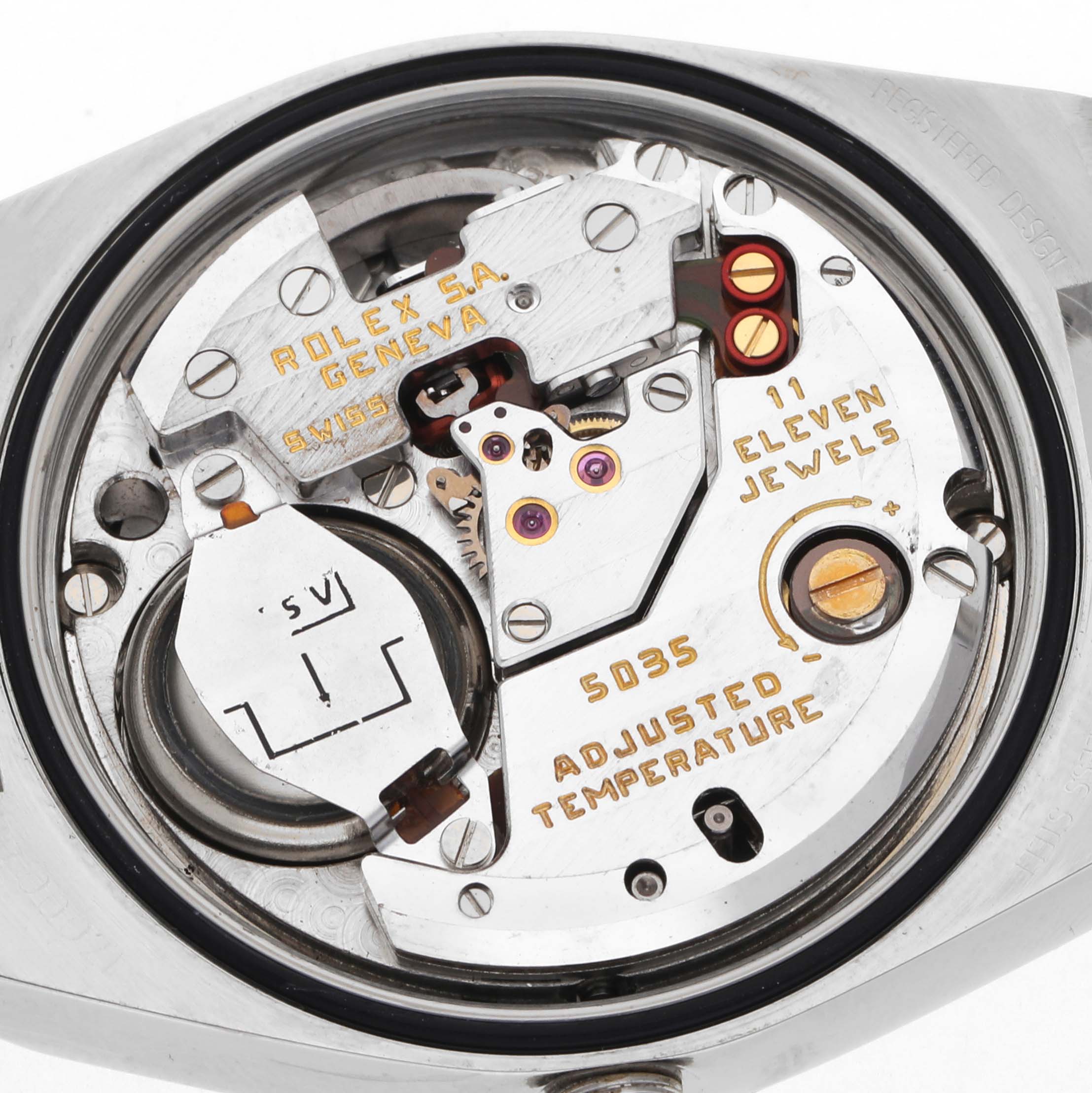The image shows the movement of a Rolex Oysterquartz 17000 Men's Stainless Steel White Dial 17000 Men's Stainless Steel White Dial watch, showcasing gears, jewels, and inscriptions from a top-down angle.
