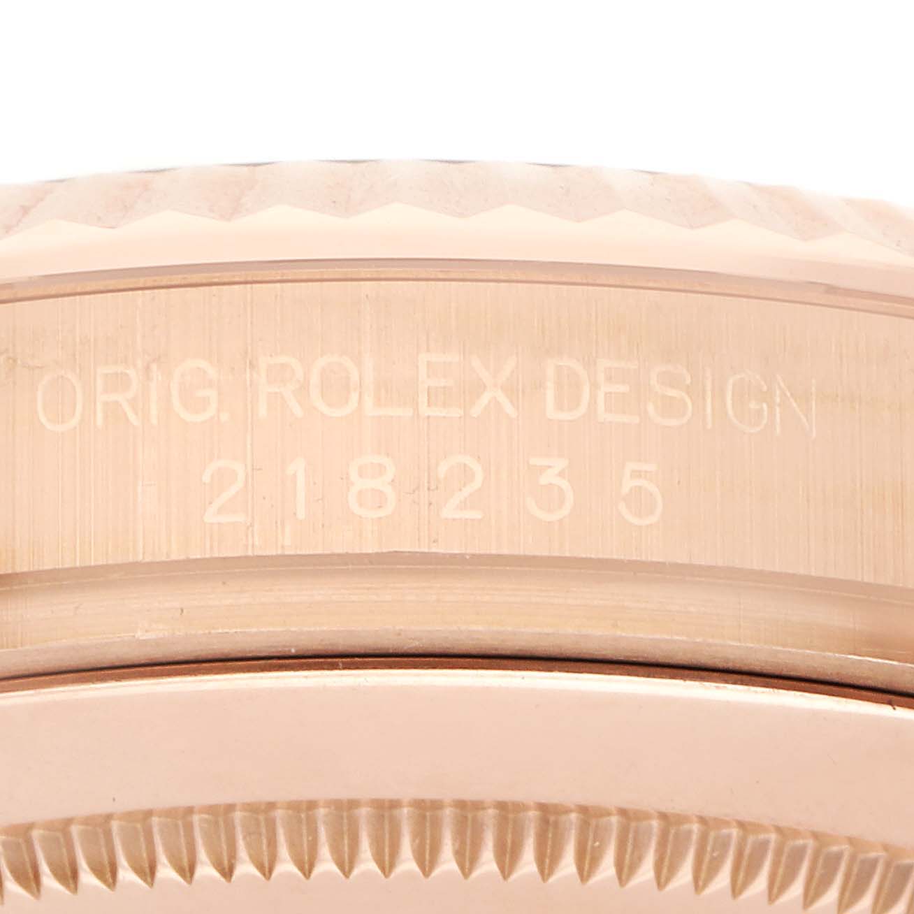 The image shows a close-up side view of a Rolex President 218235 Men's Rose Gold Pink Dial 218235 Men's Rose Gold Pink Dial model, highlighting the case edge and engraving.