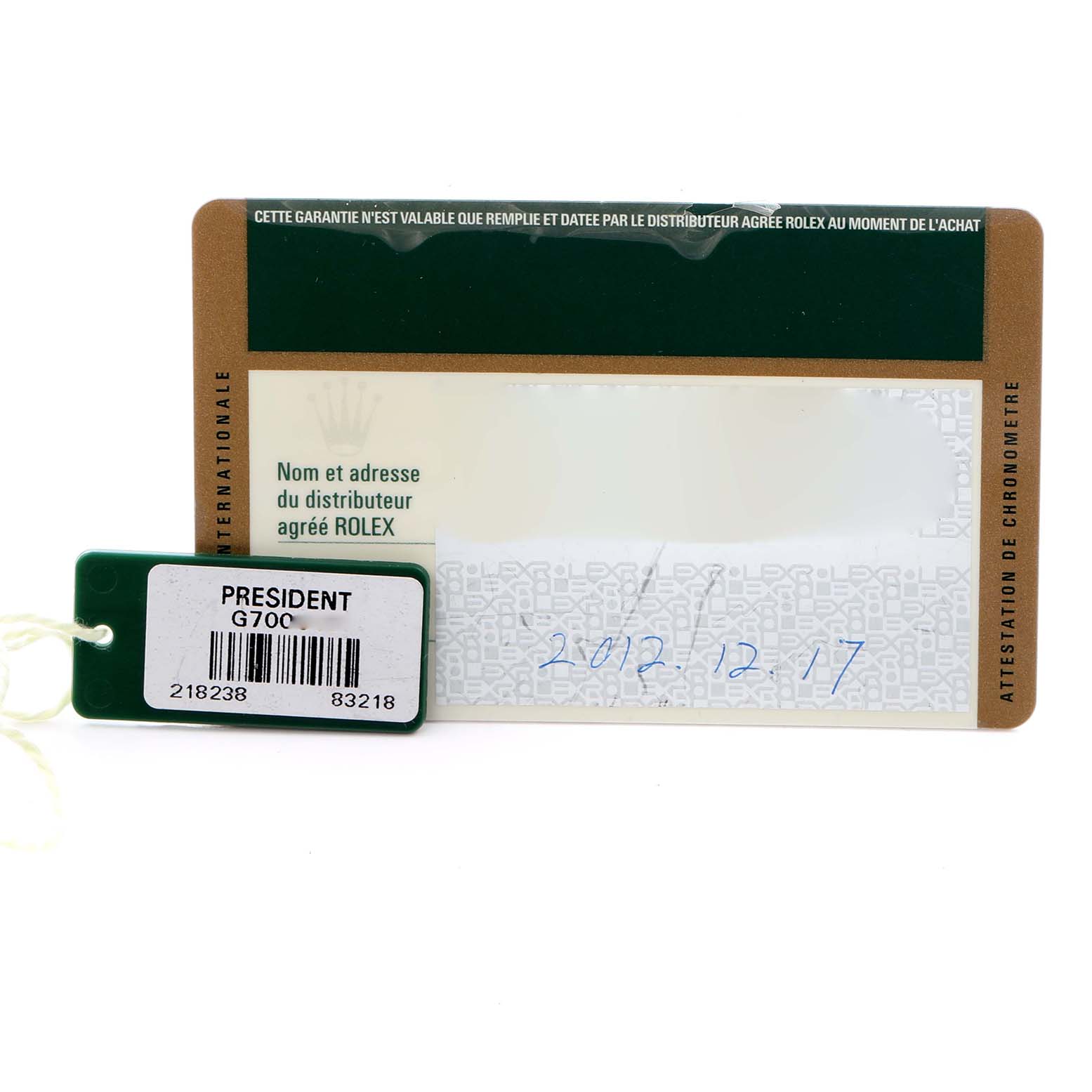The image shows the warranty card and tag of a Rolex President 218238 Men's Yellow Gold Champagne Dial 218238 Men's Yellow Gold Champagne Dial model, viewed flat from above.