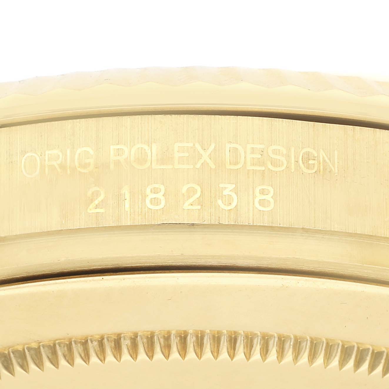 The image shows a close-up of the side engraving on the case of a Rolex President 218238 Men
s Yellow Gold Silver Dial 218238 Men
s Yellow Gold Silver Dial model watch.