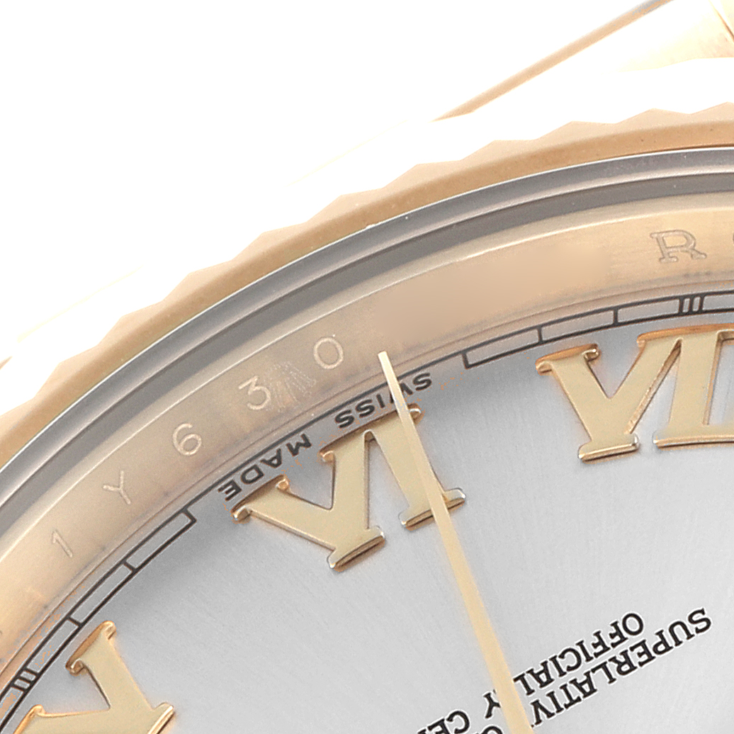 The image shows a partial close-up of a Rolex President 218238 Men
s Yellow Gold Silver Dial 218238 Men
s Yellow Gold Silver Dial, highlighting the bezel, dial with Roman numeral markers, and hands.