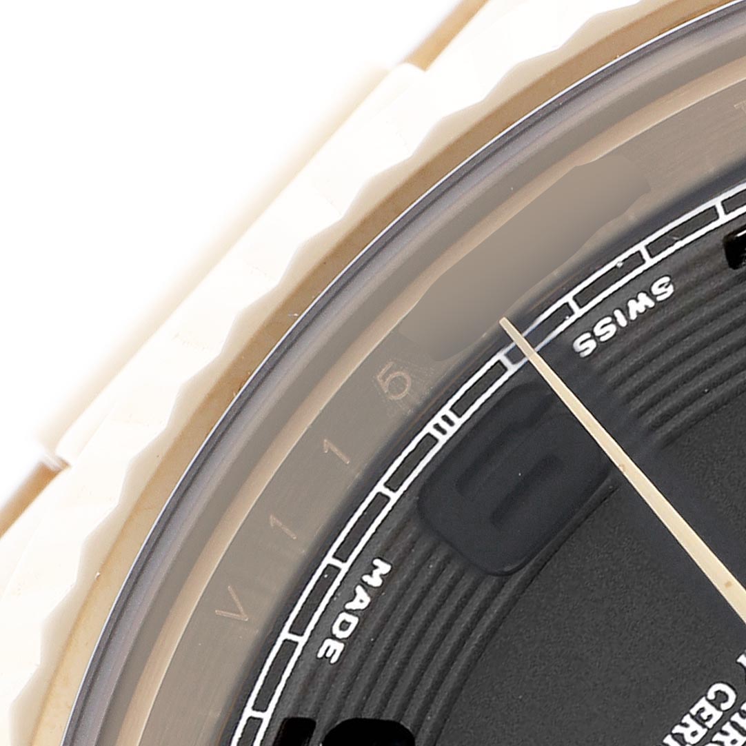 The image shows a close-up angle of a Rolex President 218238 Men's Yellow Gold Black Dial 218238 Men's Yellow Gold Black Dial model, featuring part of the dial and bezel with visible hour markers.