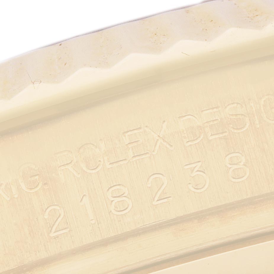 The image shows a close-up of the engraved serial number and part of the case edge on the Rolex President 218238 Men's Yellow Gold Black Dial 218238 Men's Yellow Gold Black Dial model watch.