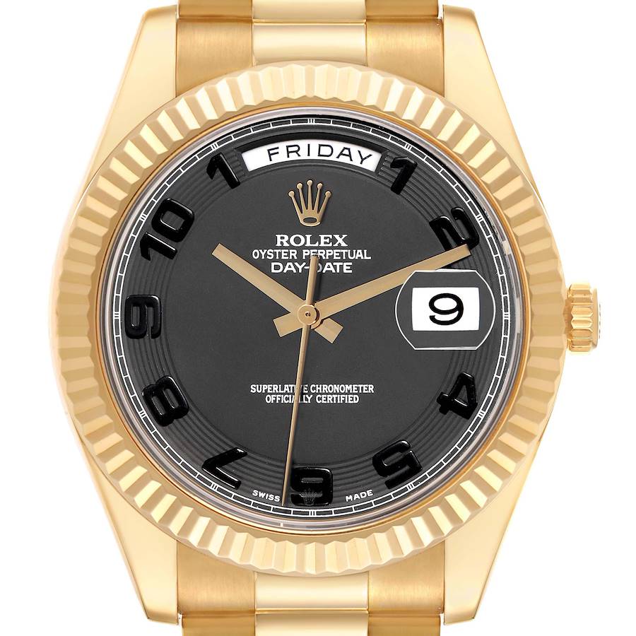 The image shows a Rolex President watch from a front angle, highlighting the gold case, black dial, day, and date features.