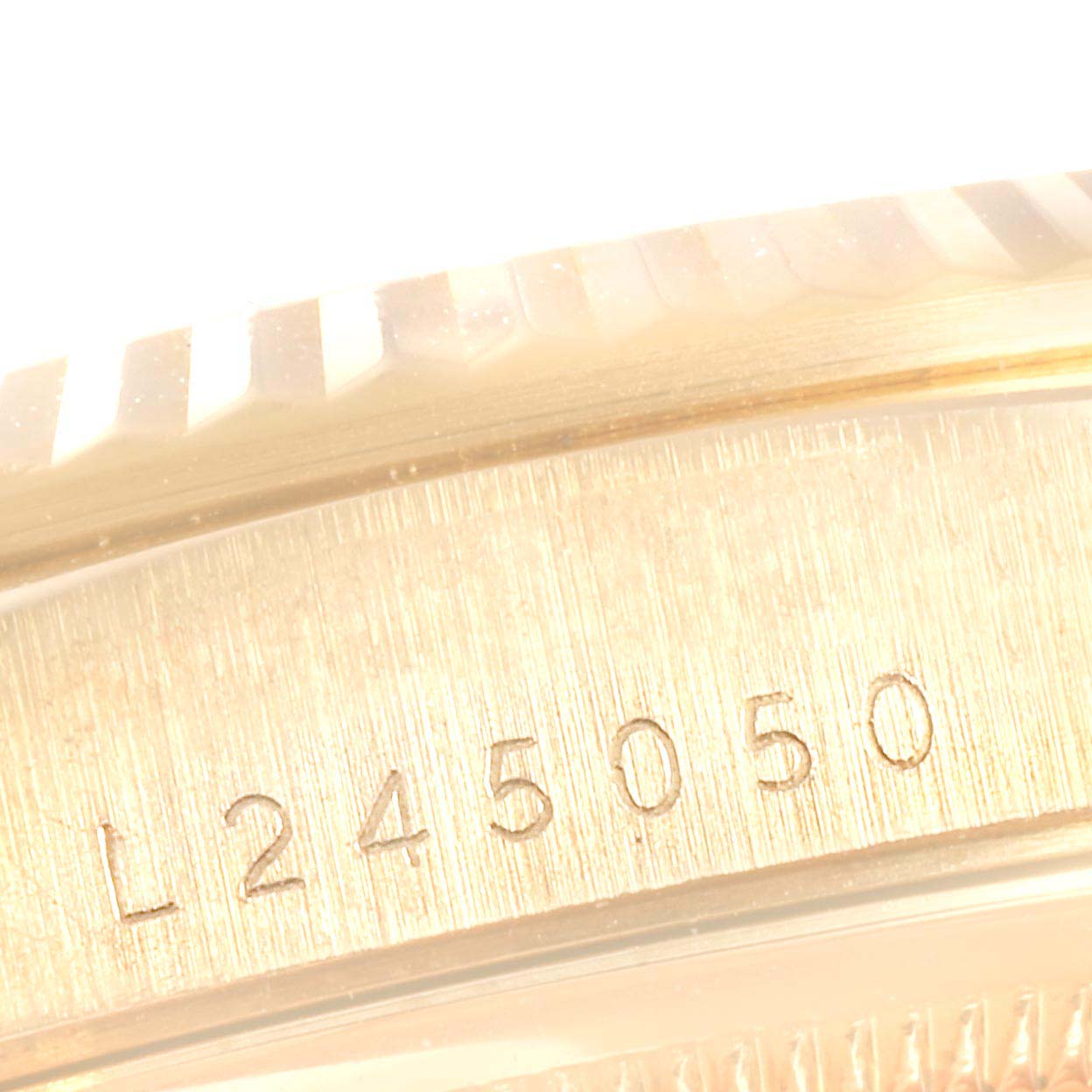 This close-up image shows the serial number engraving on the side bezel of a Rolex President 18238 Men
s Yellow Gold Blue Dial 18238 Men
s Yellow Gold Blue Dial watch.