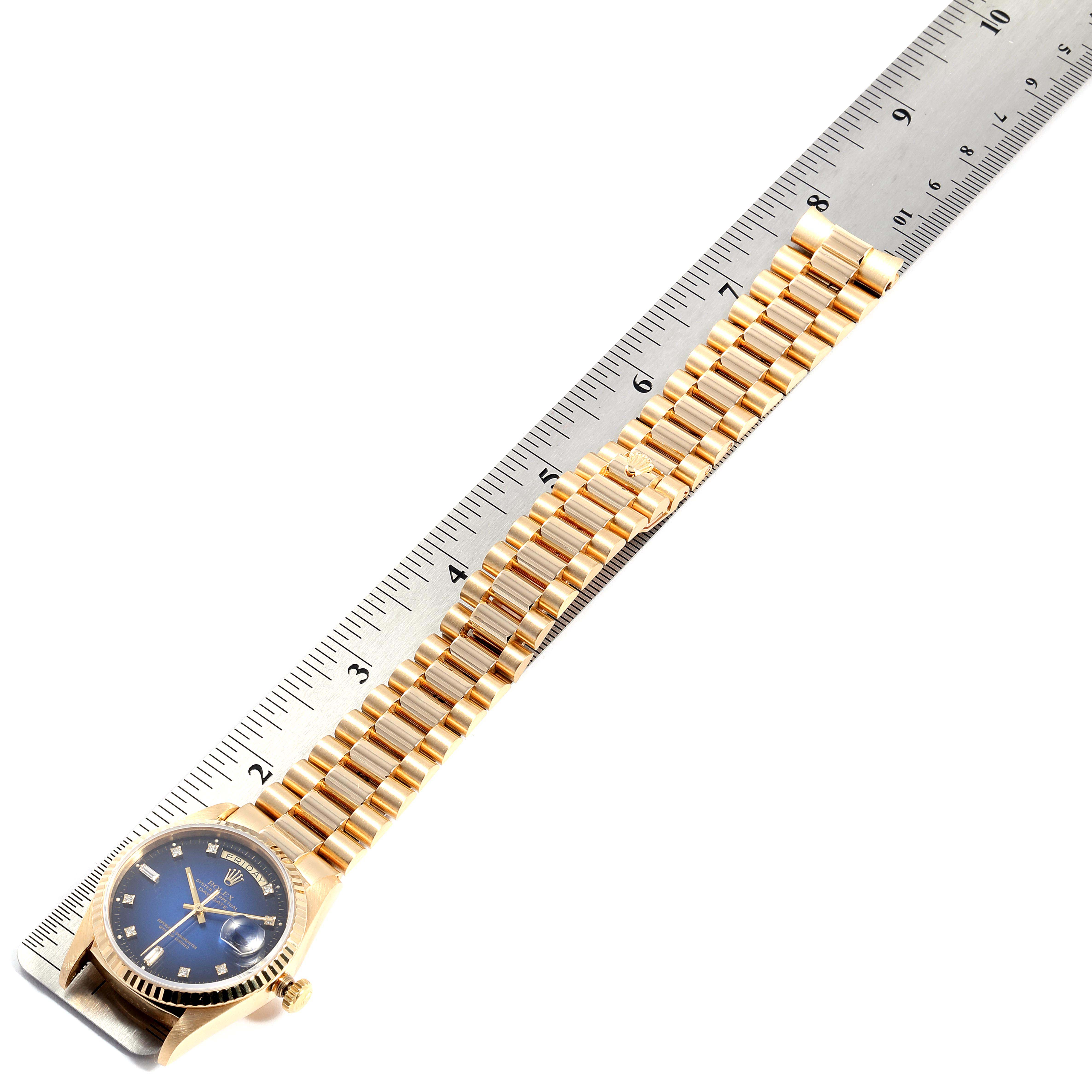The image shows a Rolex President 18238 Men
s Yellow Gold Blue Dial 18238 Men
s Yellow Gold Blue Dial watch model placed alongside a ruler, highlighting the full length of the band.