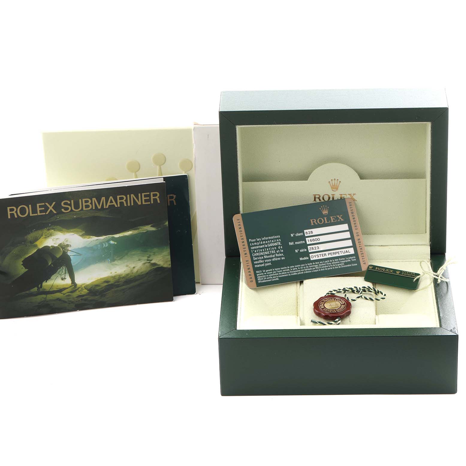 The image shows the packaging and accessories for a Rolex Sea-Dweller 16600 Men's Stainless Steel Black Dial 16600 Men's Stainless Steel Black Dial, including the box, warranty card, tag, and booklets.