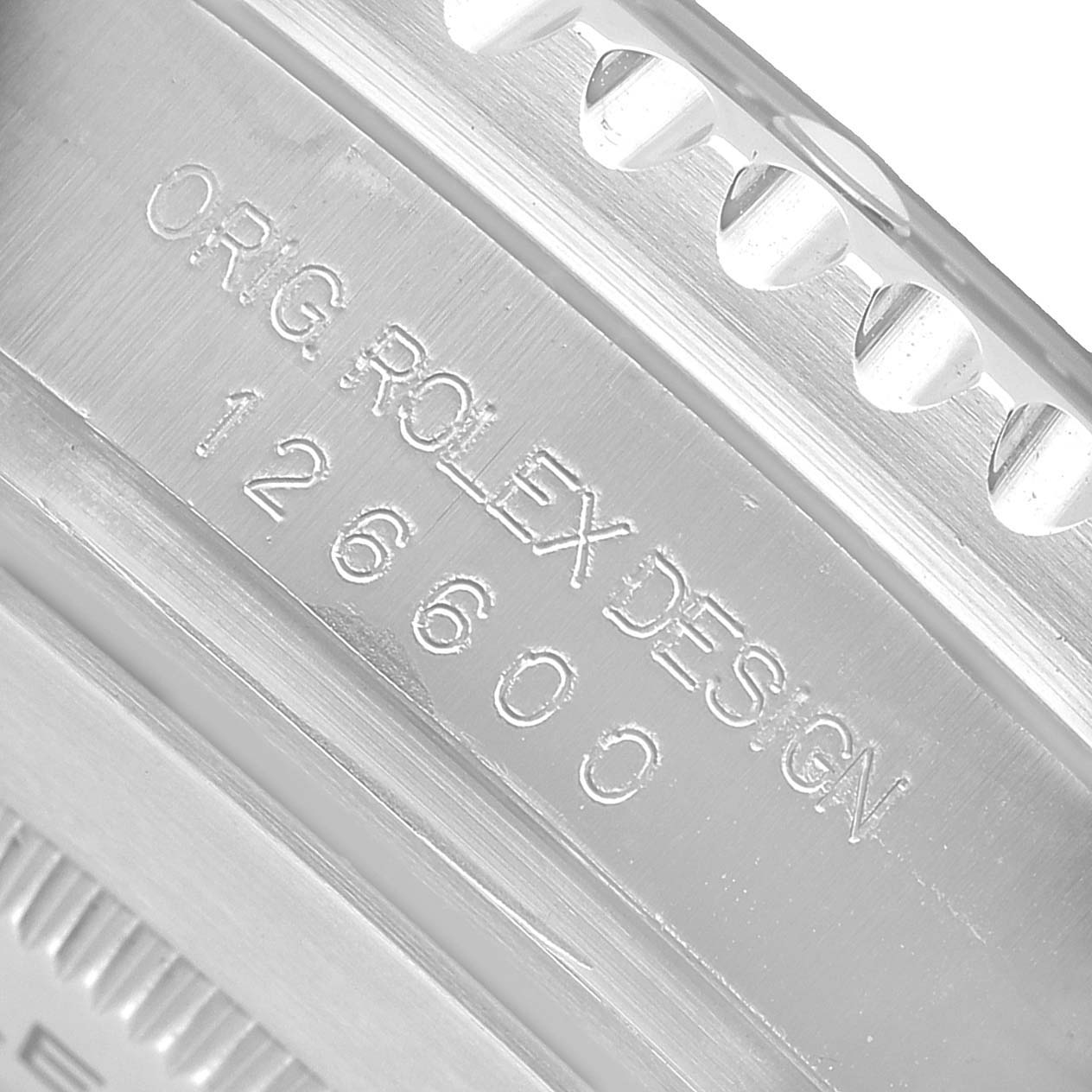 The image shows a close-up of the side of a Rolex Sea-Dweller 126600 Men's Stainless Steel Black Dial watch, highlighting the engraved model and design details.