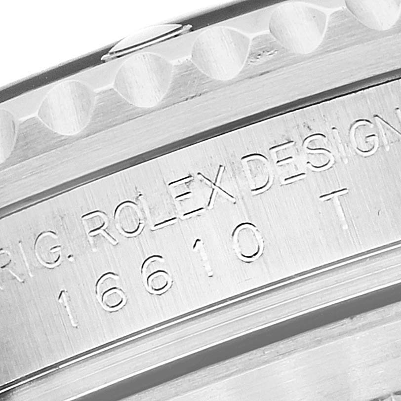 Close-up of the side of a Rolex Submariner 16610 Men
s Stainless Steel Black Dial 16610 Men
s Stainless Steel Black Dial showing the engraved model number and "ROLEX DESIGN" text.