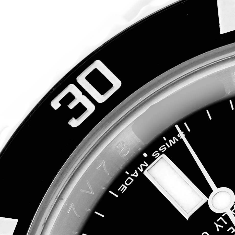 This close-up image of a Rolex Submariner 116610 Men
s Stainless Steel Black Dial 116610 Men
s Stainless Steel Black Dial watch shows part of the bezel with the number 30 and the words "Swiss Made" on the dial.