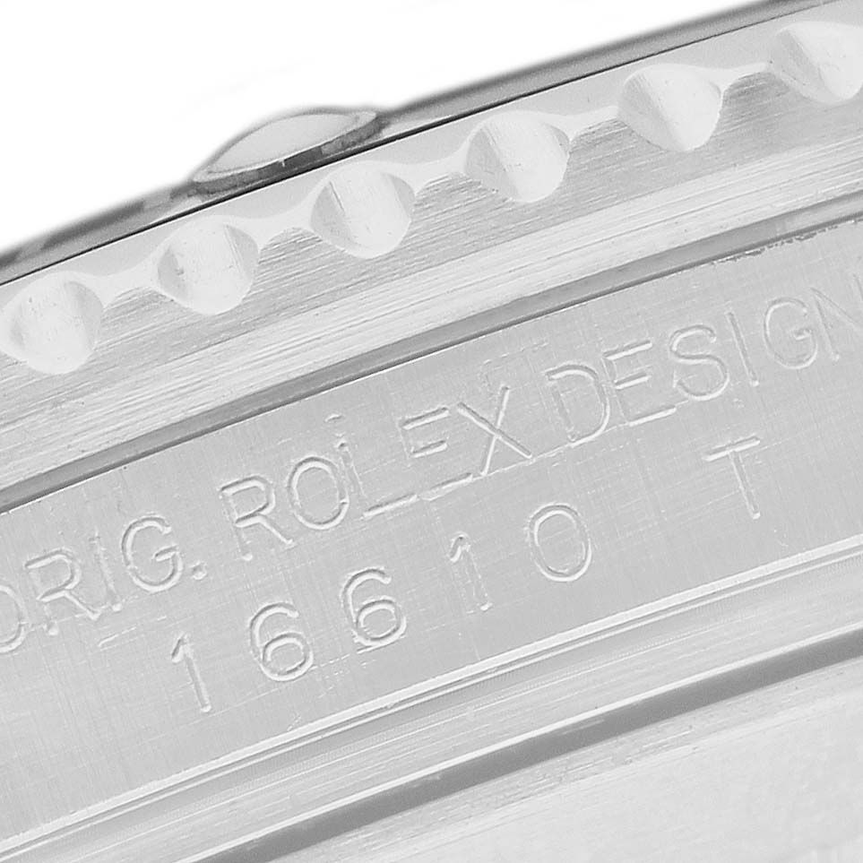 The image shows the engraved side of the bezel on a Rolex Submariner 16610 Men's Stainless Steel Black Dial watch, displaying model details.