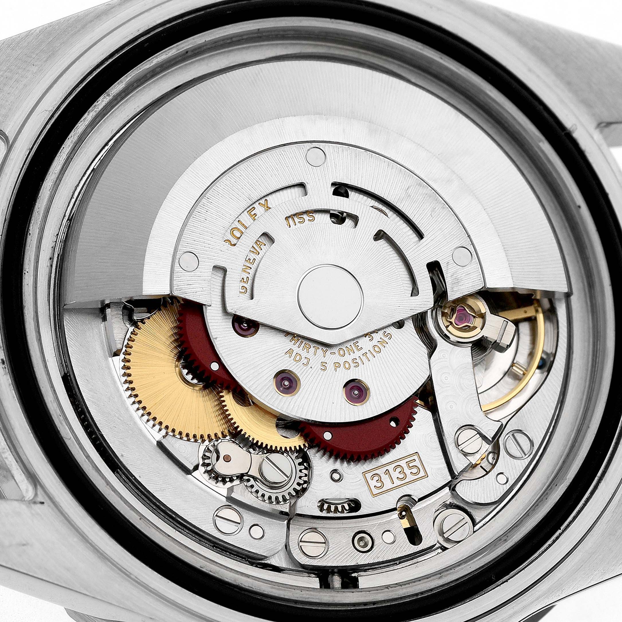 The image shows a close-up of the Rolex Submariner 16610 Men's Stainless Steel Black Dial's movement with gears and the rotor visible.