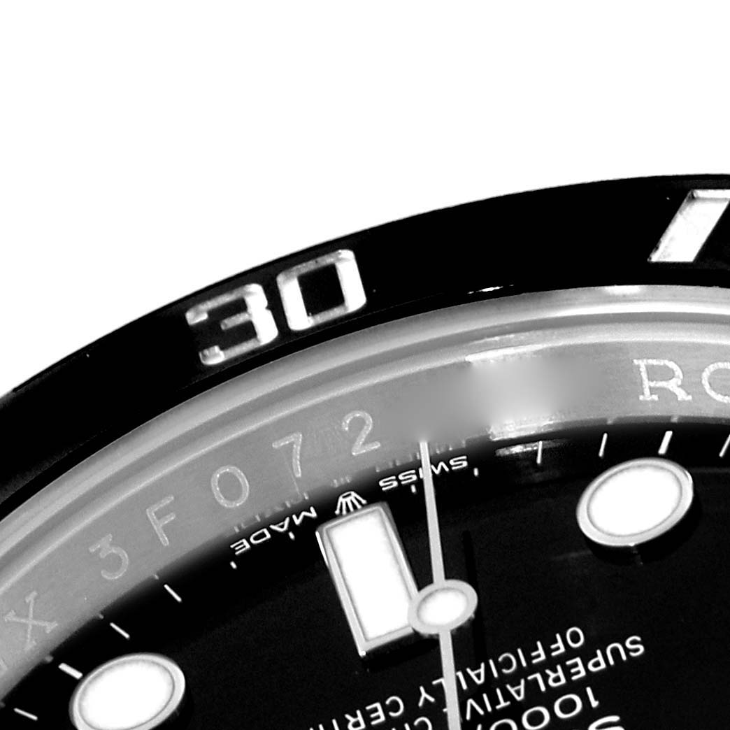 This image shows a close-up of the bezel and part of the dial of a Rolex Submariner 124060 Men
s Stainless Steel Black Dial 124060 Men
s Stainless Steel Black Dial watch.