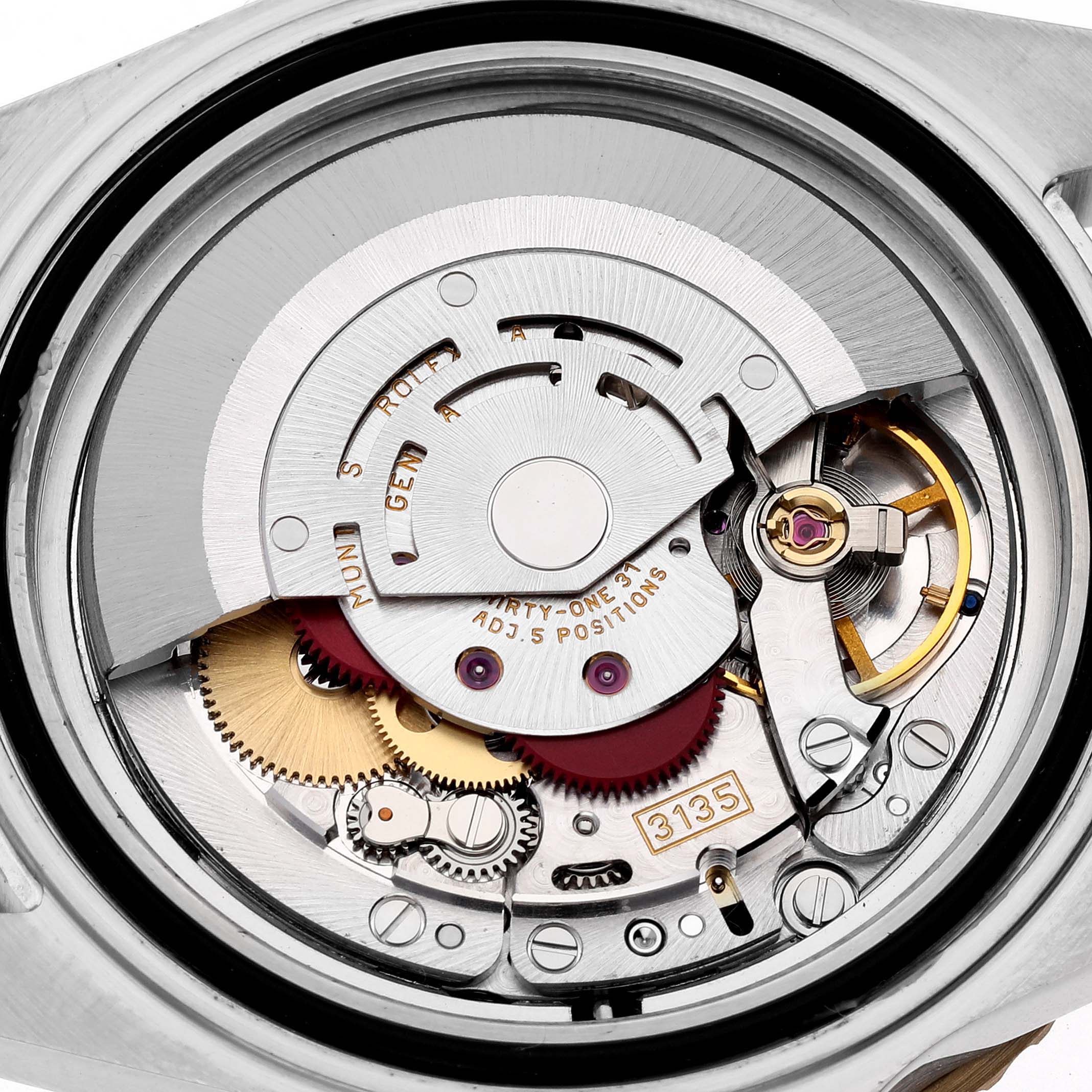 This image shows the internal mechanism of a Rolex Submariner 16613 Men's Steel and Gold (two tone) Champagne Dial 16613 Men's Steel and Gold (two tone) Champagne Dial watch, showcasing gears and the automatic movement components.