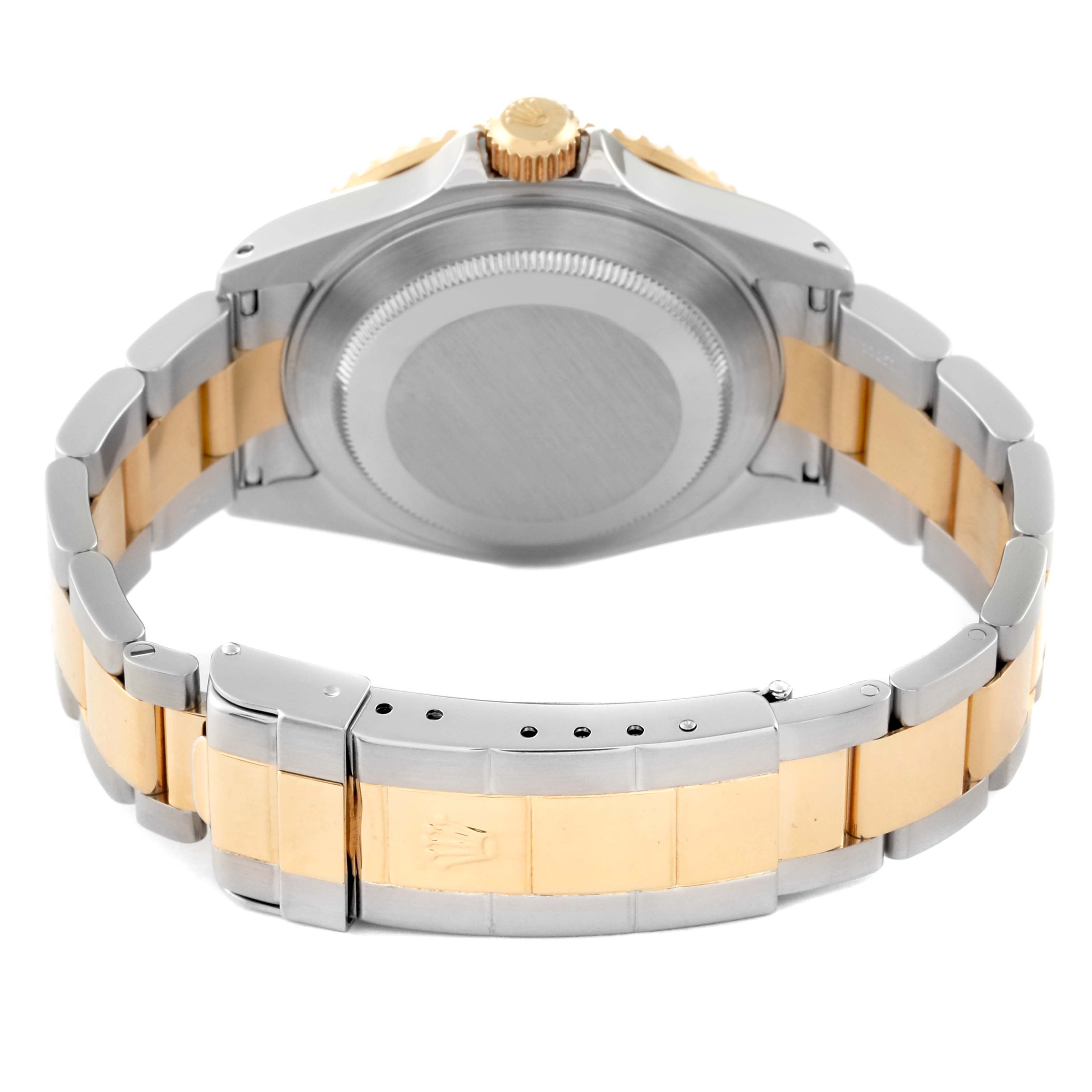 This image shows the back of a Rolex Submariner 16613 Men's Steel and Gold (two tone) Champagne Dial 16613 Men's Steel and Gold (two tone) Champagne Dial watch, highlighting its case back, crown, and the two-tone bracelet with clasp.