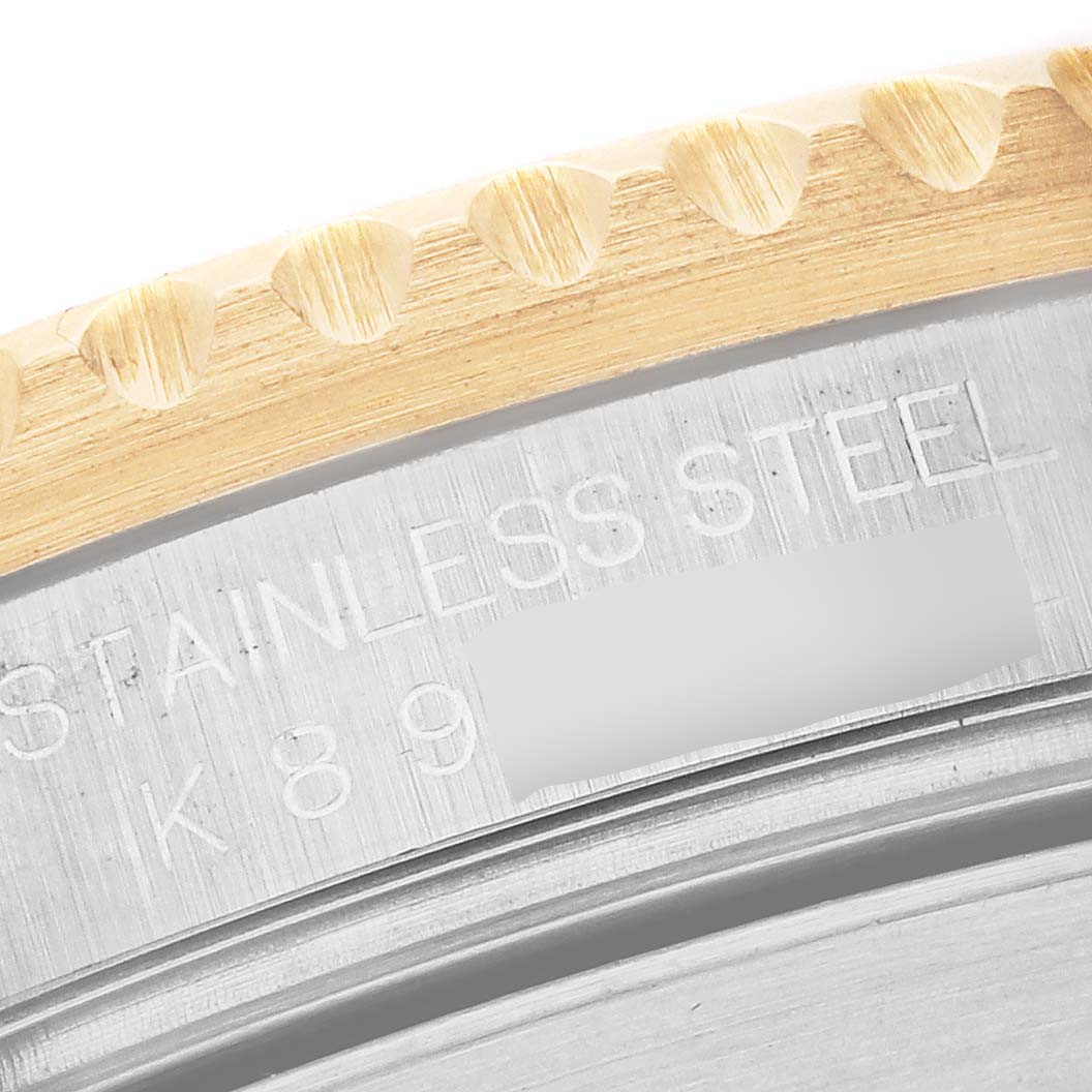 The image shows a close-up of the bezel edge and engraved serial number on the side of a Rolex Submariner 16613 Men's Steel and Gold (two tone) Champagne Dial 16613 Men's Steel and Gold (two tone) Champagne Dial watch case.