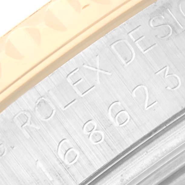 This close-up shows the engraved inner bezel and part of the outer bezel of the Rolex Yacht-Master 168623 Men's Steel and Gold (two tone) Grey Dial 168623 Men's Steel and Gold (two tone) Grey Dial watch.