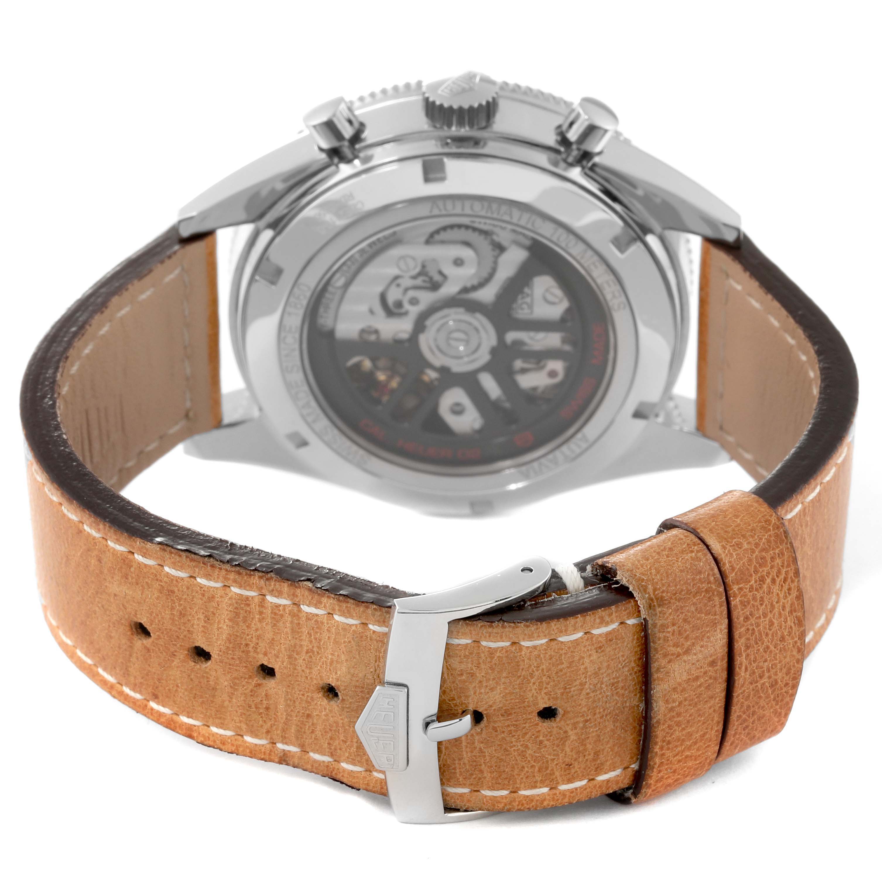 The image shows the back of a Tag Heuer Autavia CBE2110 Men's Stainless Steel Black Dial CBE2110 Men's Stainless Steel Black Dial watch, highlighting its movement and leather strap with a Heuer-branded buckle.