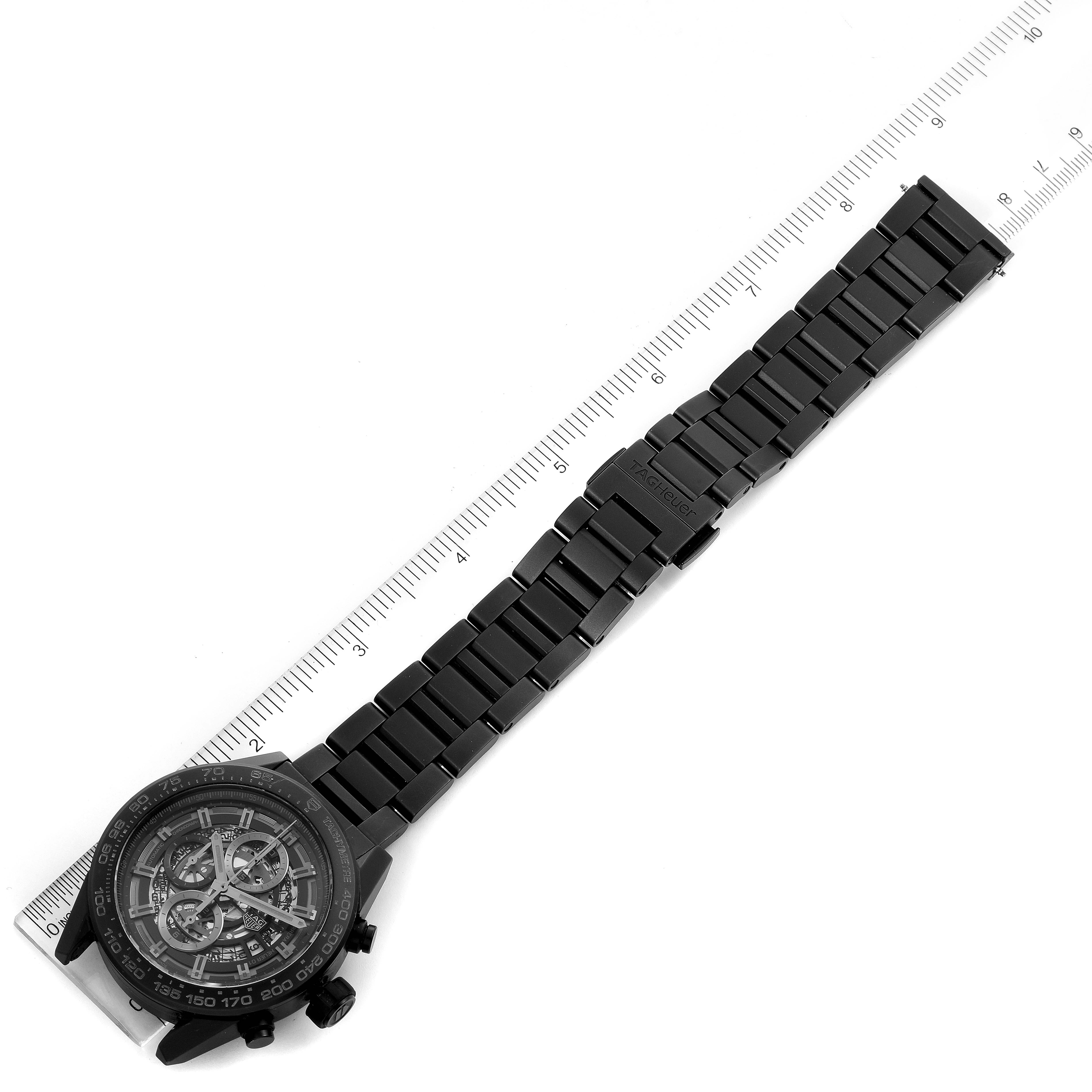 The image shows a top-down view of the Tag Heuer Carrera CAR2A91.BH0742 Men's Titanium Black Dial CAR2A91.BH0742 Men's Titanium Black Dial watch and its entire bracelet placed alongside a ruler.