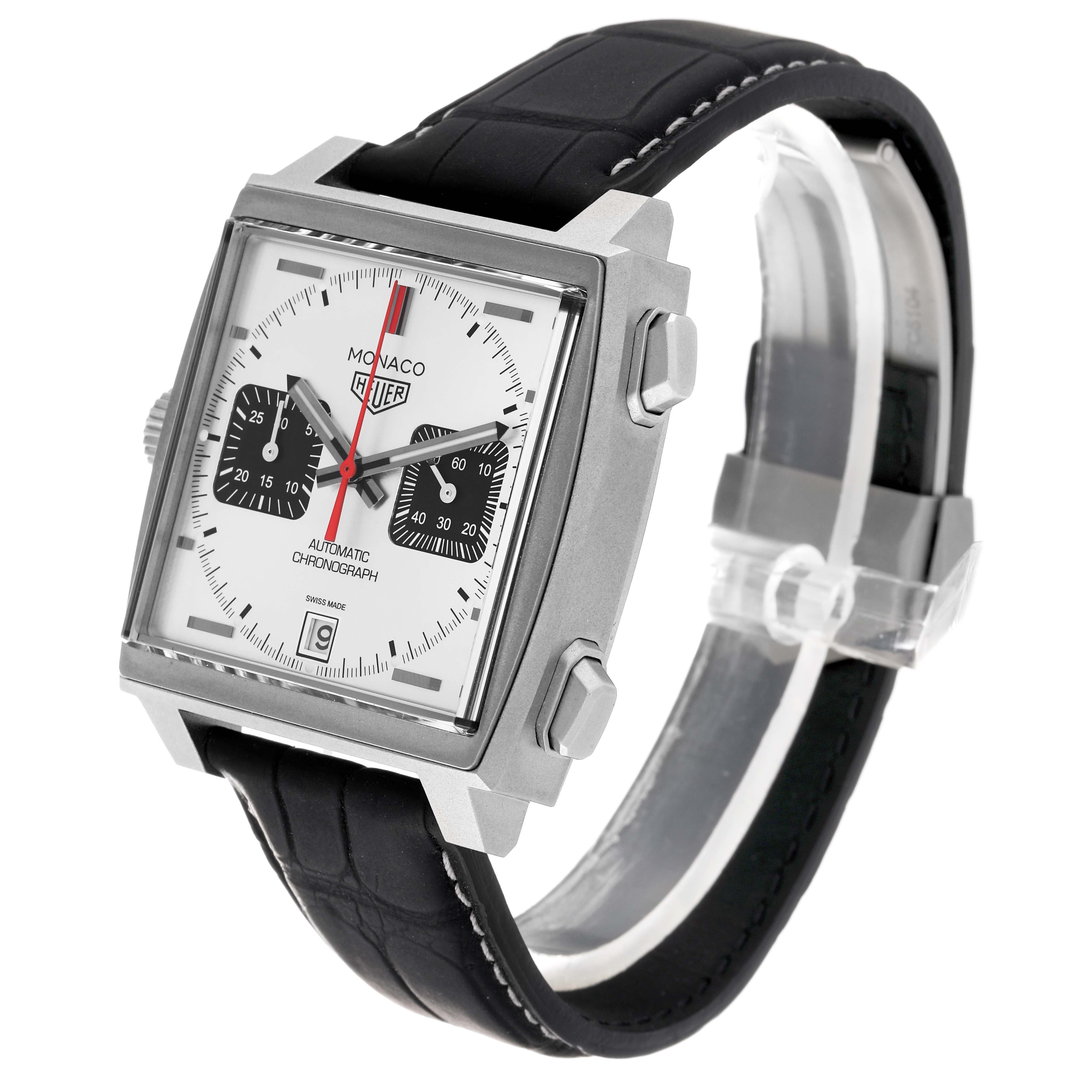 This image shows a Tag Heuer Monaco CAW218B.FC6496 Men
s Titanium Silver Dial CAW218B.FC6496 Men
s Titanium Silver Dial watch at an angled view, highlighting its square face, black leather strap, and chronograph dials.
