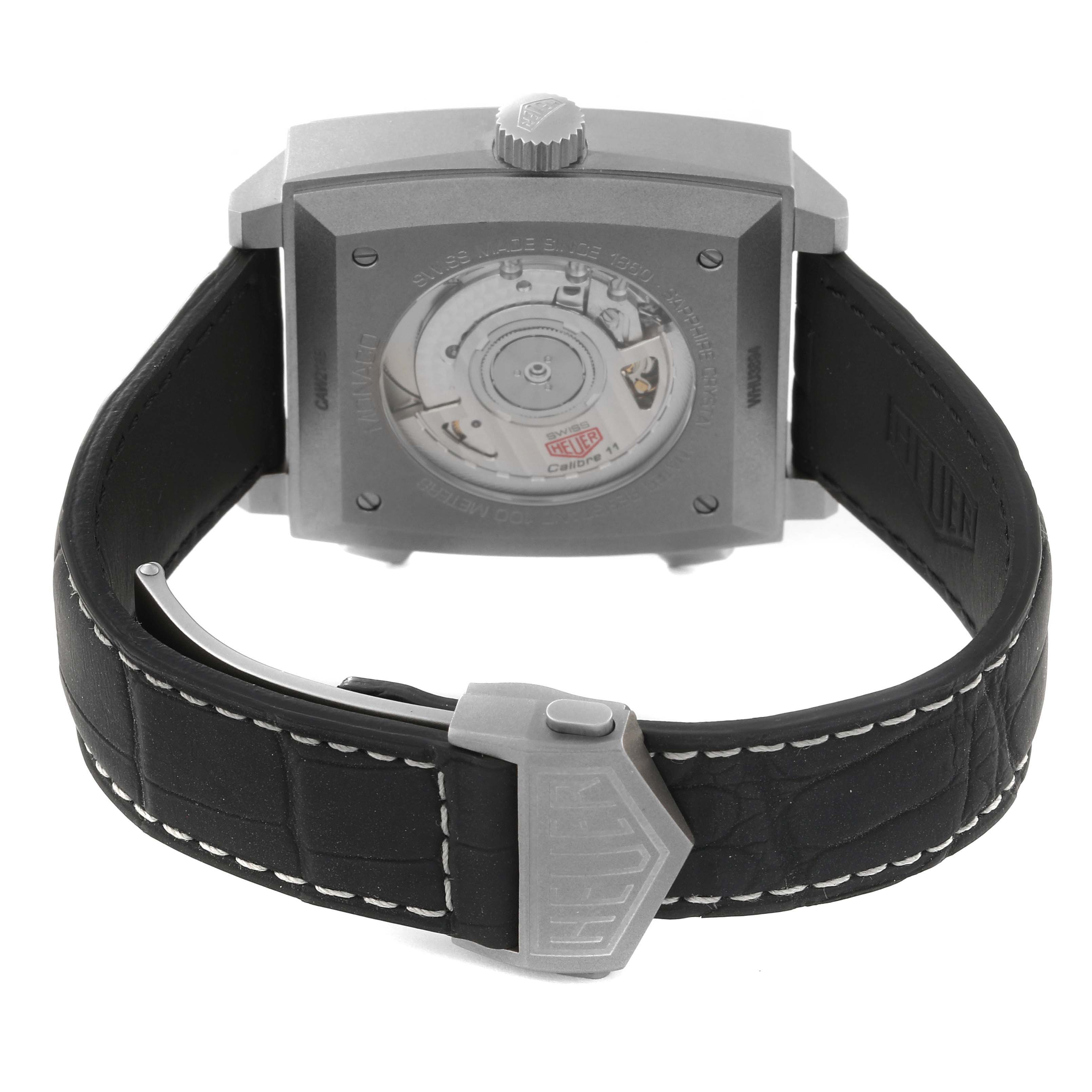 The image shows the back and strap of the Tag Heuer Monaco CAW218B.FC6496 Men
s Titanium Silver Dial CAW218B.FC6496 Men
s Titanium Silver Dial watch, highlighting the movement through a transparent case back.