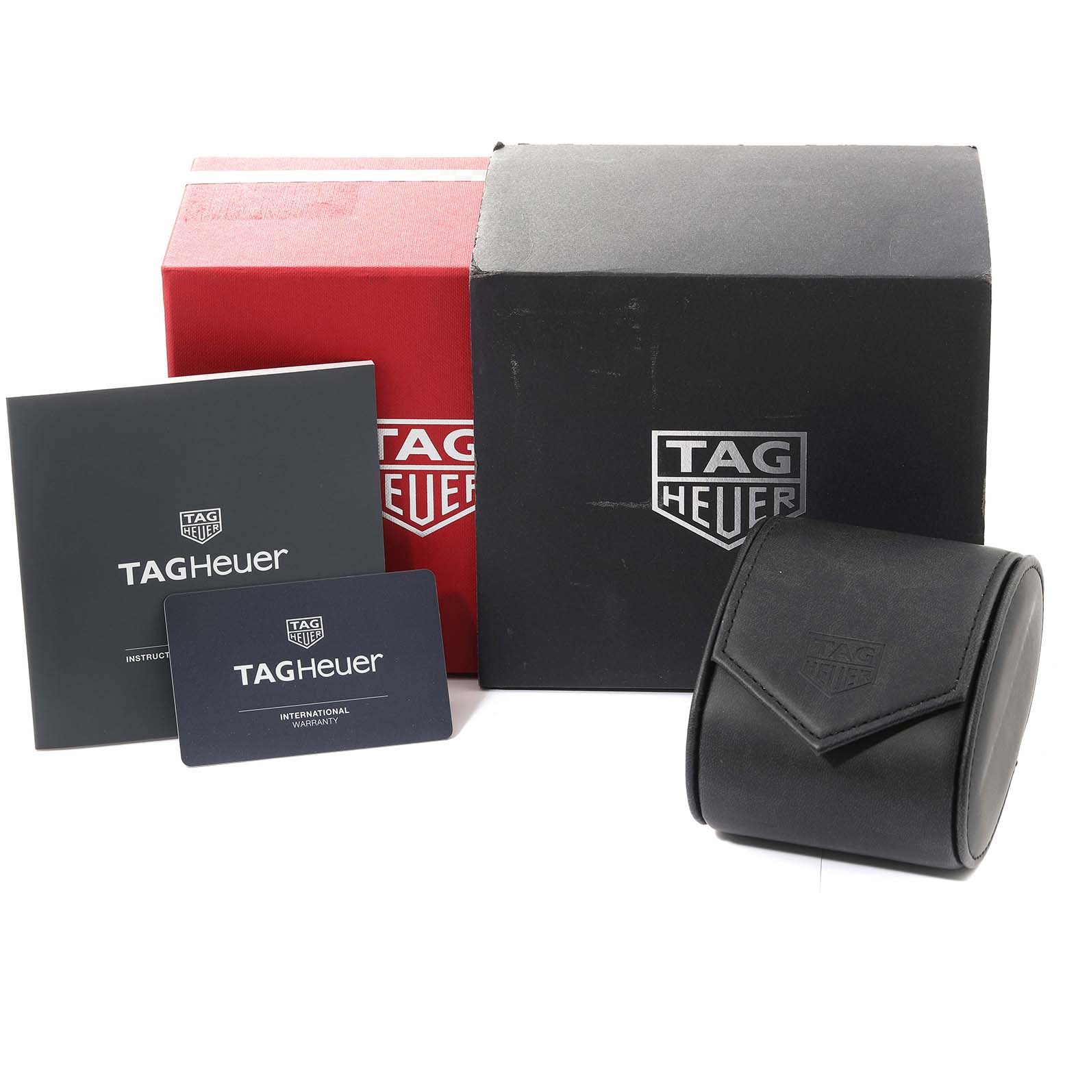 This image shows the packaging and accessories for a Tag Heuer Monaco CAW218B.FC6496 Men
s Titanium Silver Dial CAW218B.FC6496 Men
s Titanium Silver Dial model watch, including a box, warranty card, instruction manual, and watch case.