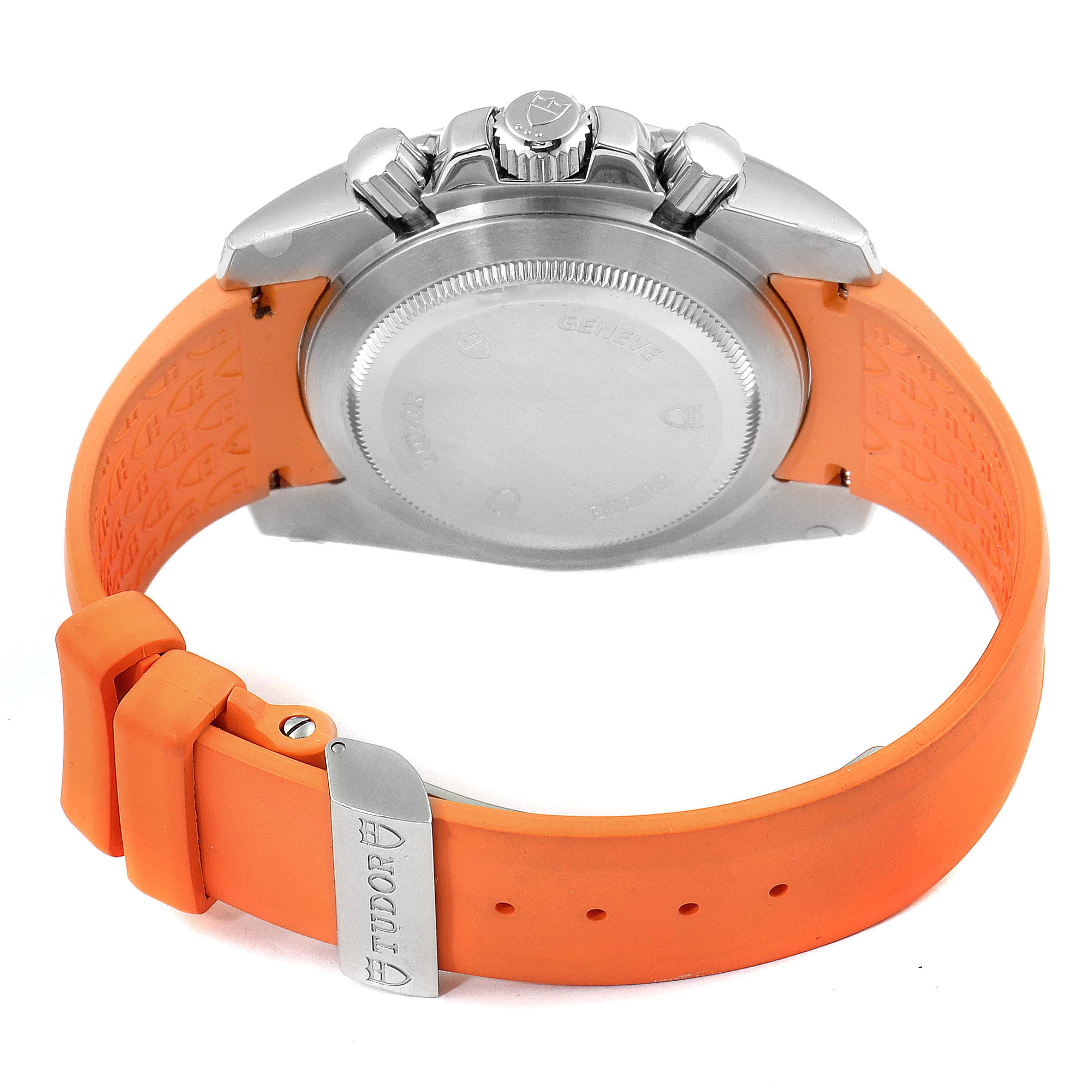 The image shows the back and side of a Tudor Grantour 20310 Men's Stainless Steel White Dial 20310 Men's Stainless Steel White Dial watch with an orange strap and metal clasp.