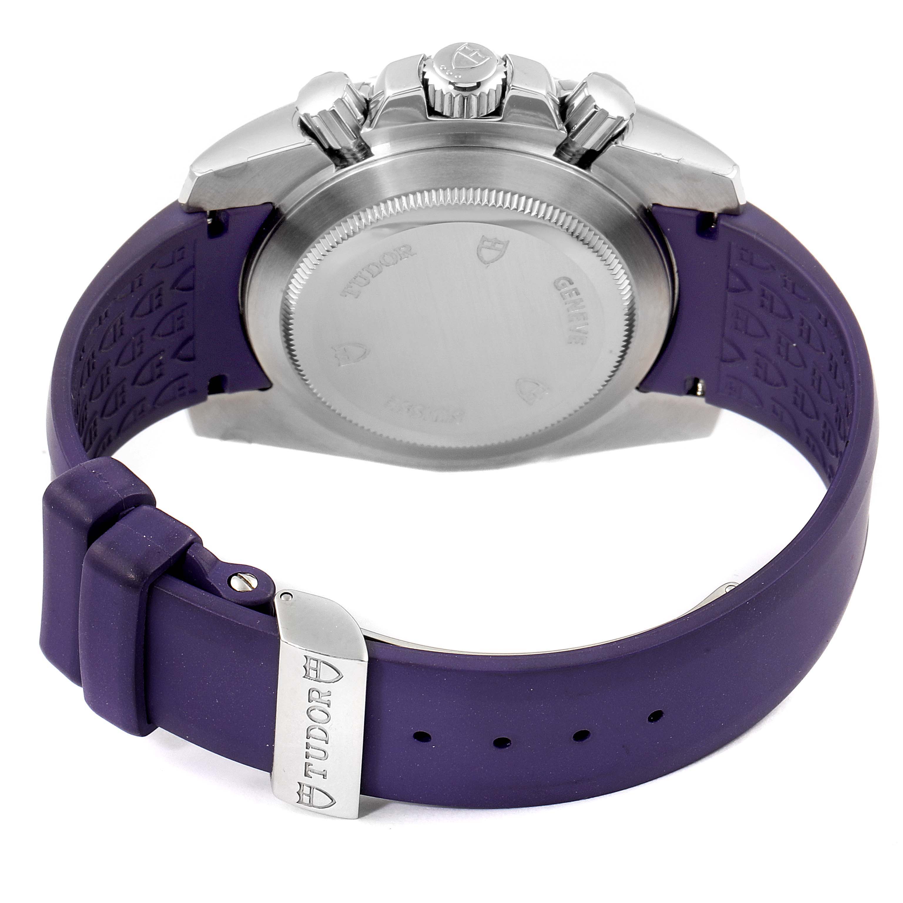 The image shows the back view of a Tudor Grantour 20310 Men's Stainless Steel White Dial 20310 Men's Stainless Steel White Dial watch, highlighting its case back, crown, pushers, and purple strap.