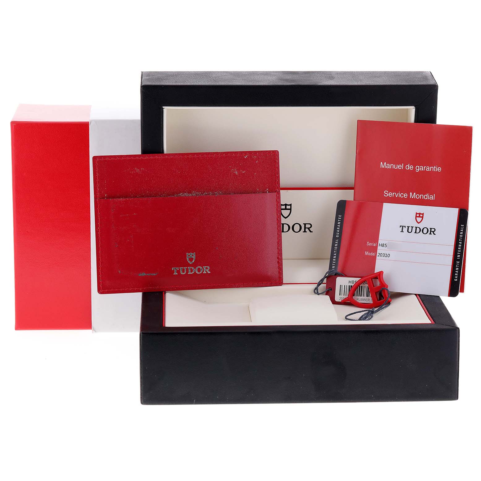 The image shows the packaging and documentation for the Tudor Grantour 20310 Men
s Stainless Steel White Dial 20310 Men
s Stainless Steel White Dial model watch, including the warranty card and manual.
