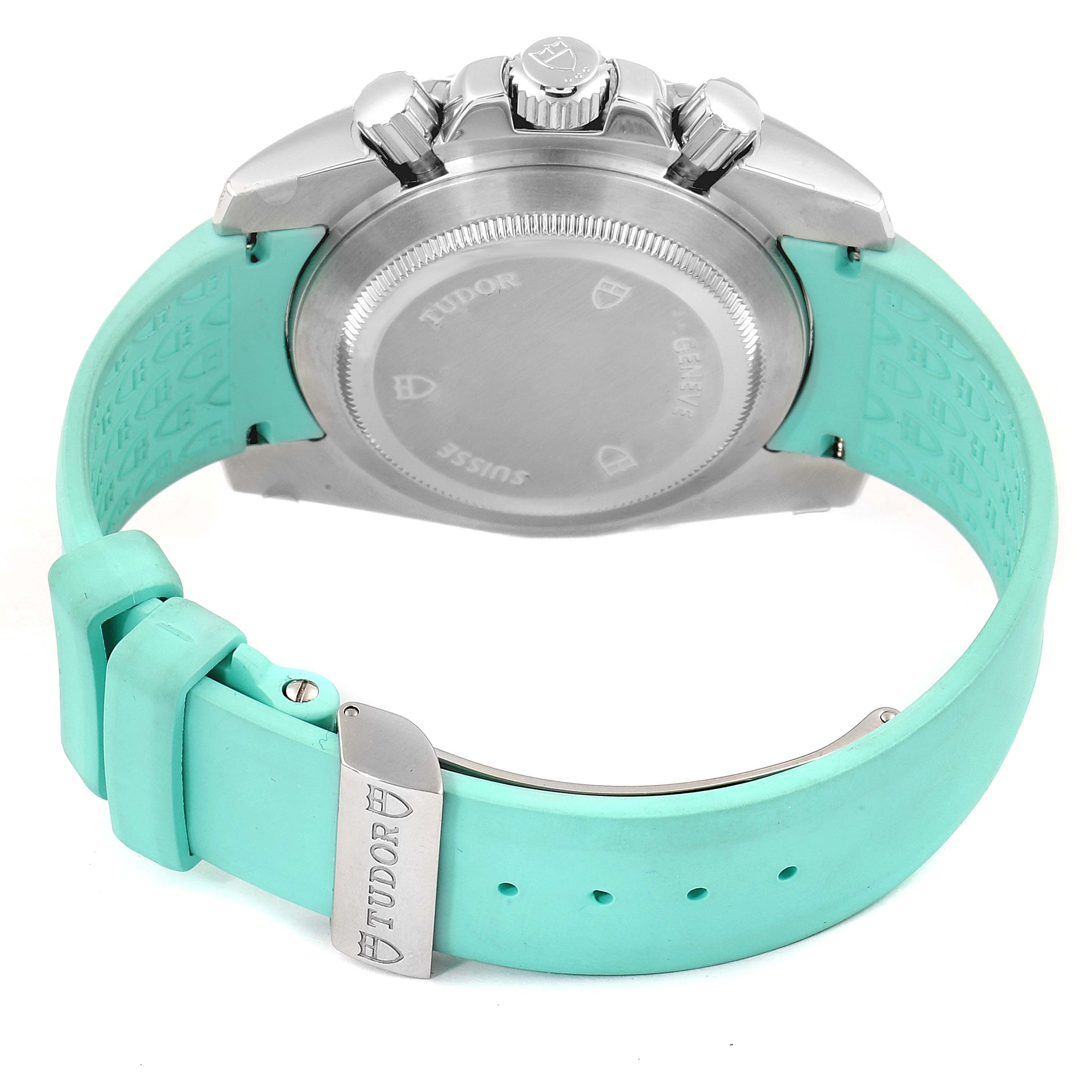 The image shows the back of a Tudor Grantour 20310 Men
s Stainless Steel White Dial 20310 Men
s Stainless Steel White Dial watch with a light blue strap and visible clasp.