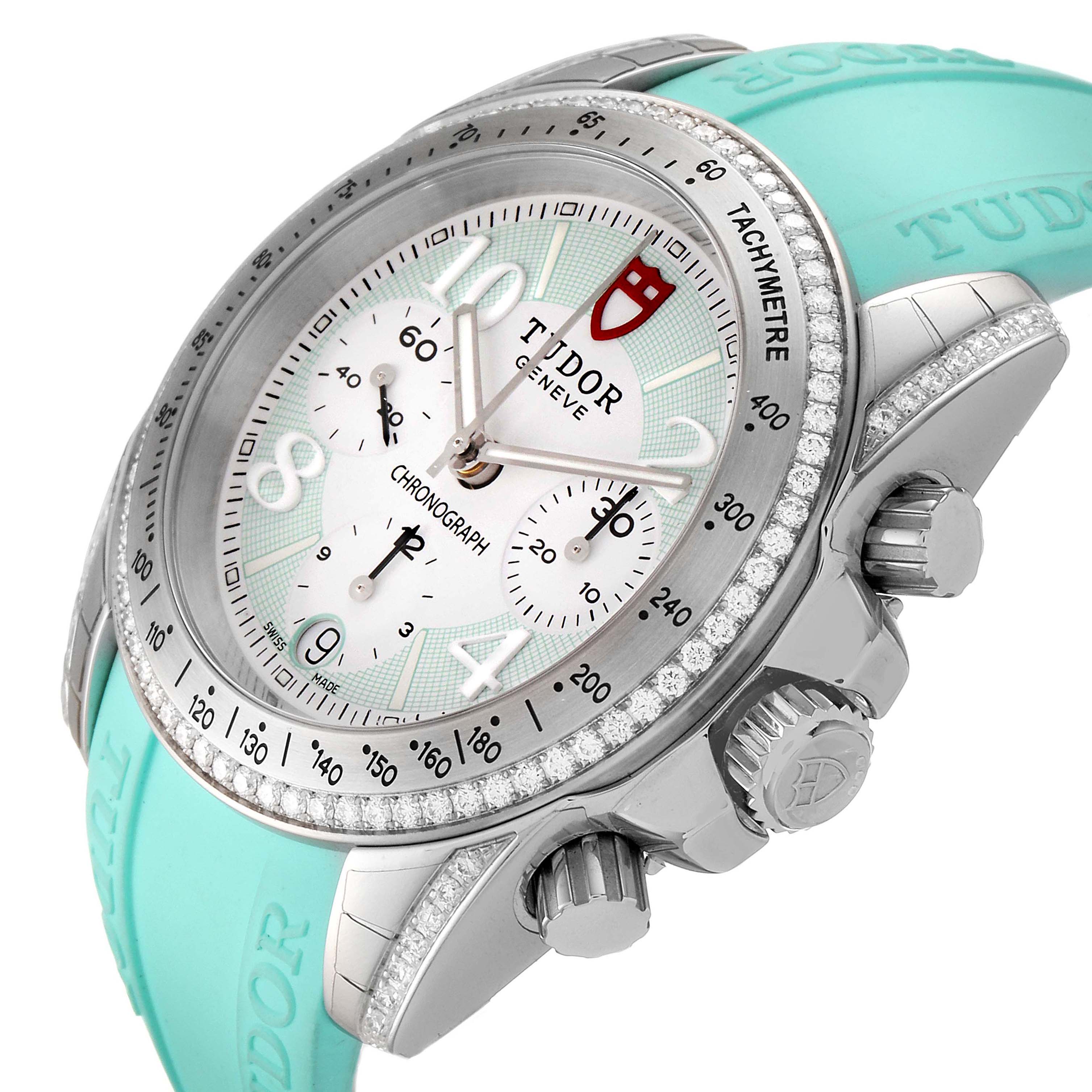 The Tudor Grantour 20310 Men
s Stainless Steel White Dial 20310 Men
s Stainless Steel White Dial watch is shown at an angle highlighting its dial, bezel, crown, and turquoise strap.