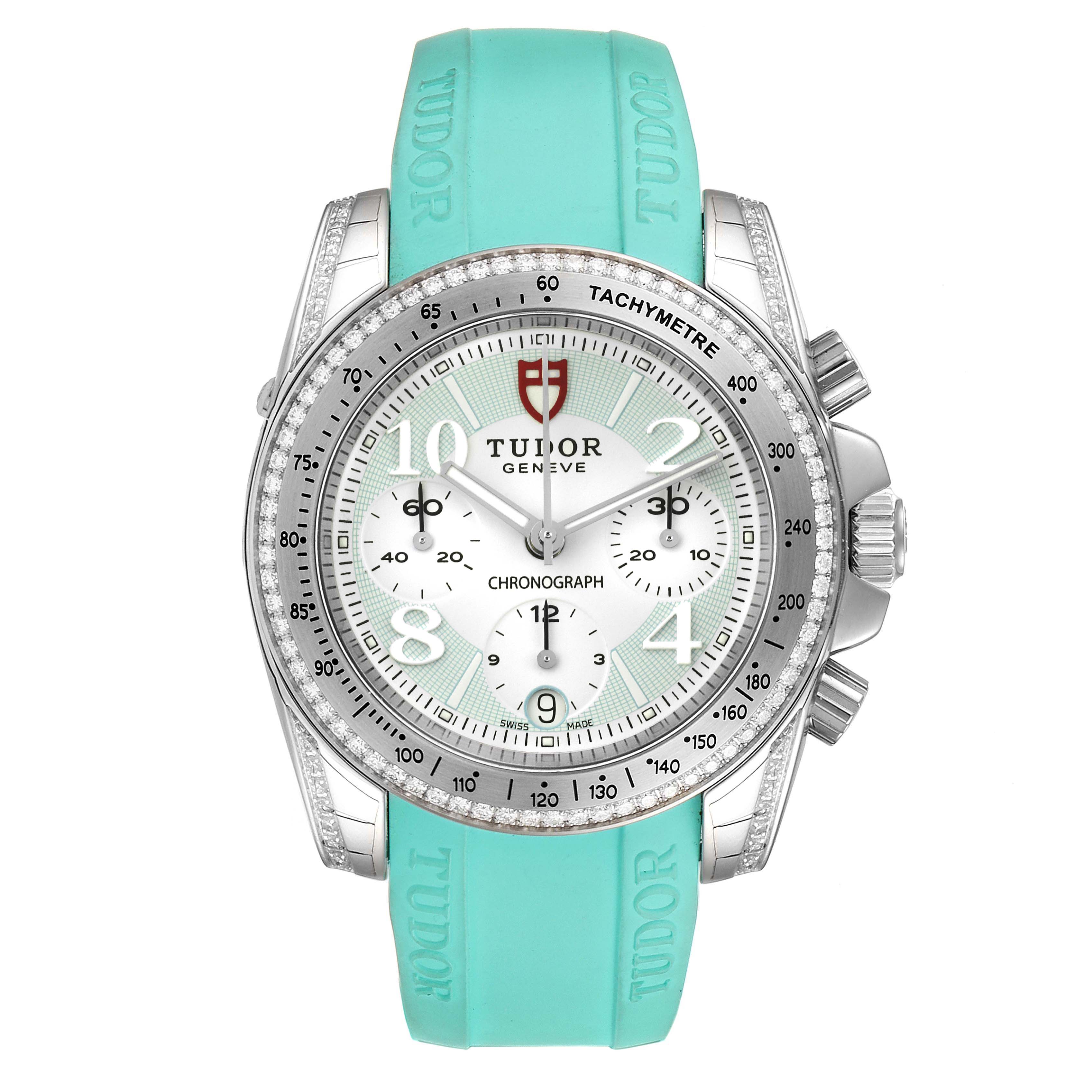 The image shows a front view of a Tudor Grantour 20310 Men
s Stainless Steel White Dial 20310 Men
s Stainless Steel White Dial watch with a turquoise strap, tachymeter bezel, and chronograph sub-dials.