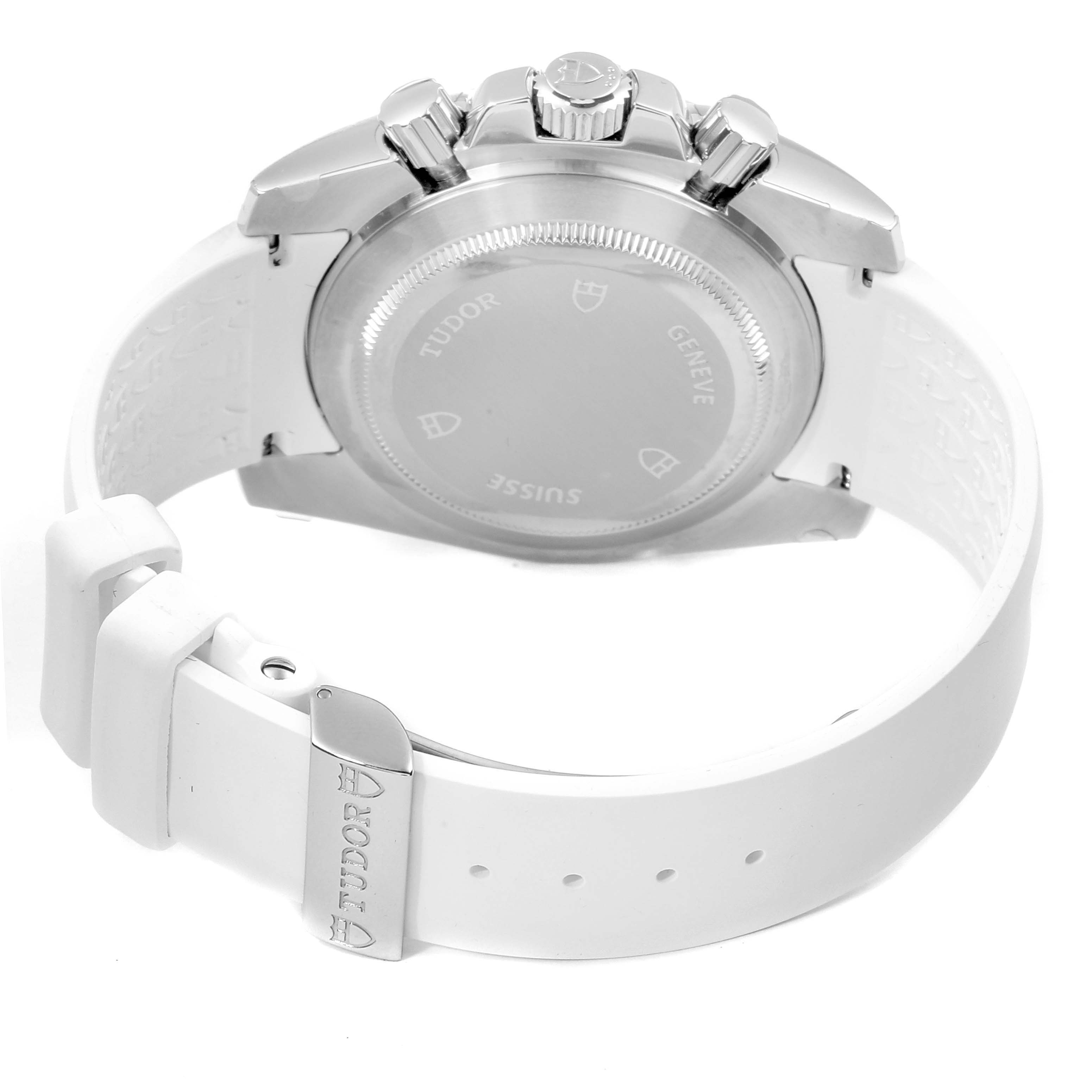 The image shows the back and crown side of a Tudor Grantour 20310 Men's Stainless Steel White Dial 20310 Men's Stainless Steel White Dial watch with a visible case back and white strap.