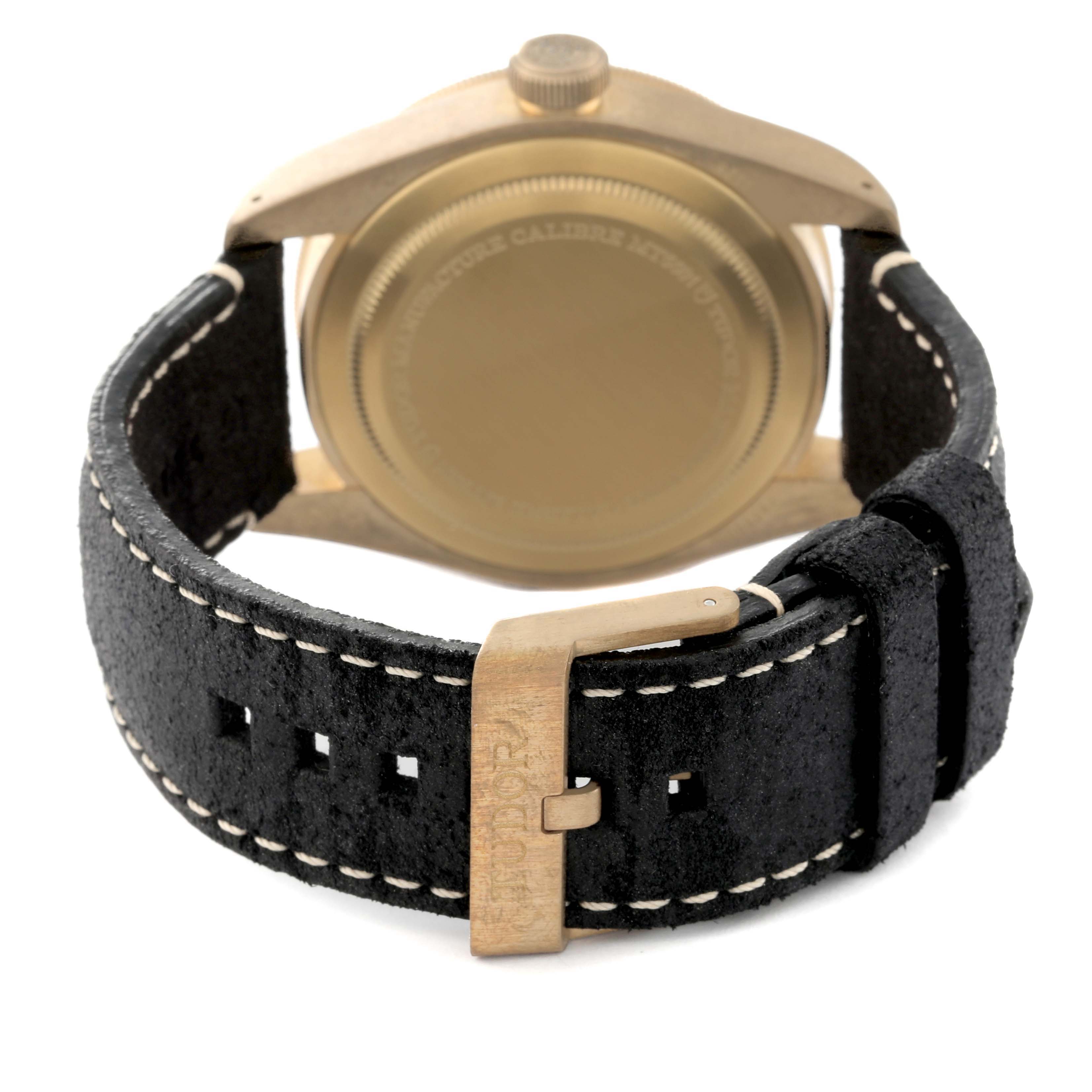 The image shows the back view of a Tudor Heritage Black Bay 79250B Men's Bronze Grey Dial 79250B Men's Bronze Grey Dial watch and its leather strap.